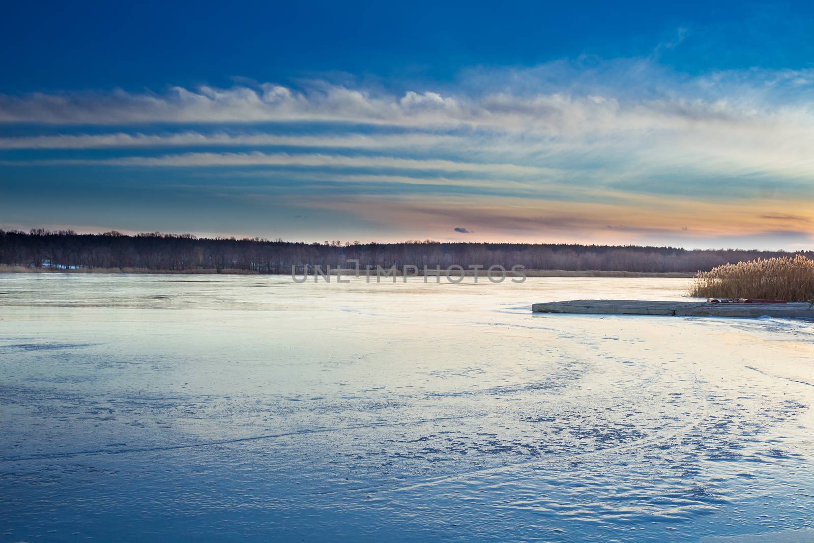 Winter paysage landscape of sunset evening iced frozen lake river