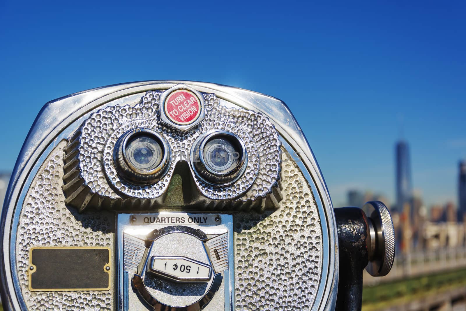 Close up of coin operated binoculars with New York City skyline in background