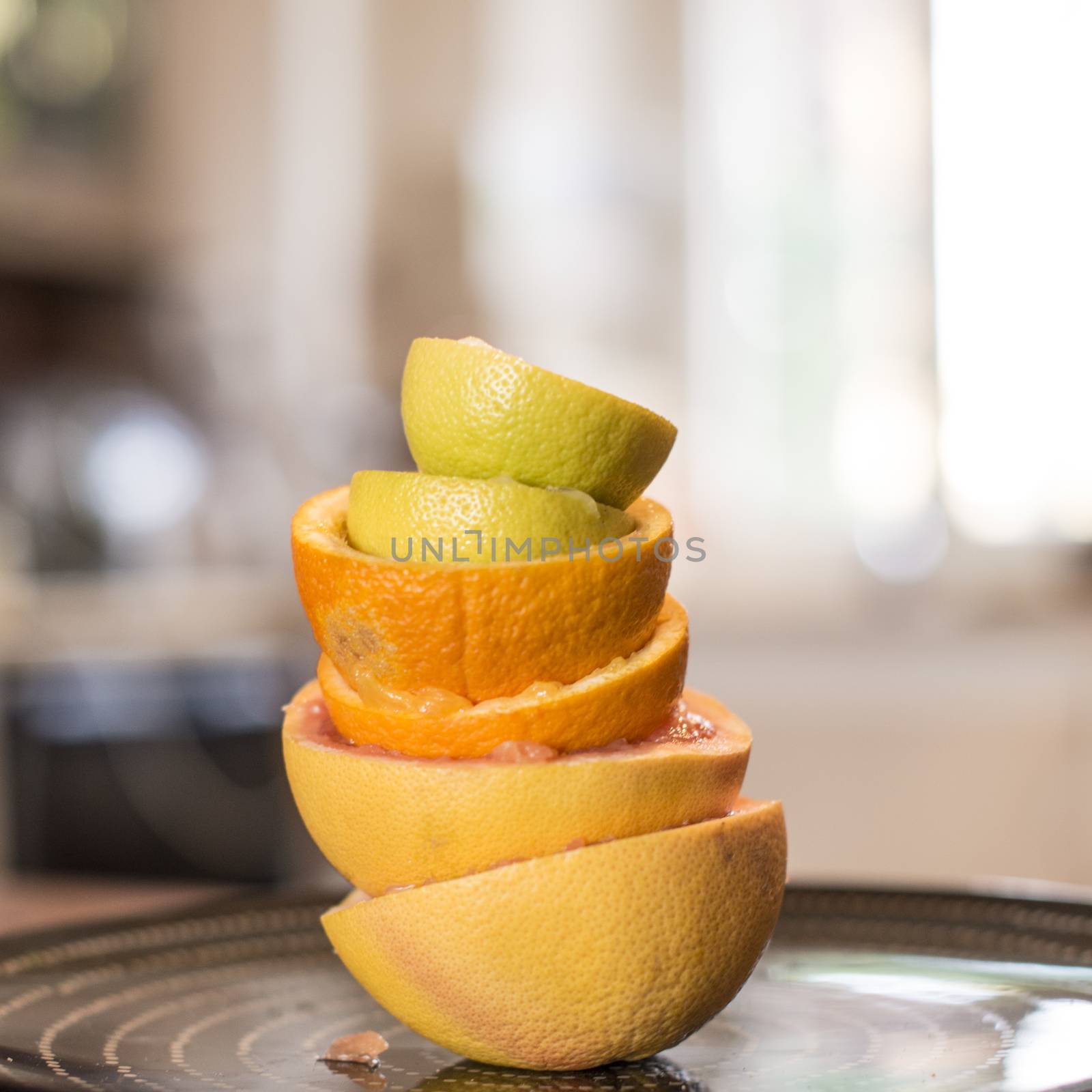 citrus fruit squeezed into the kitchen stacked peels to form a tower on a black plate