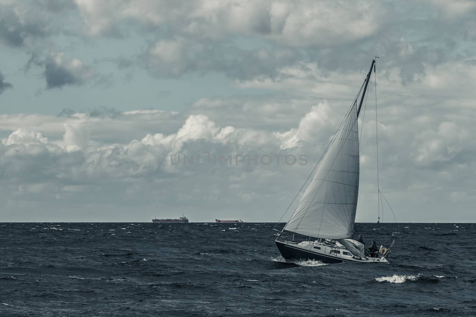 Blue sailboat at storm by sengnsp