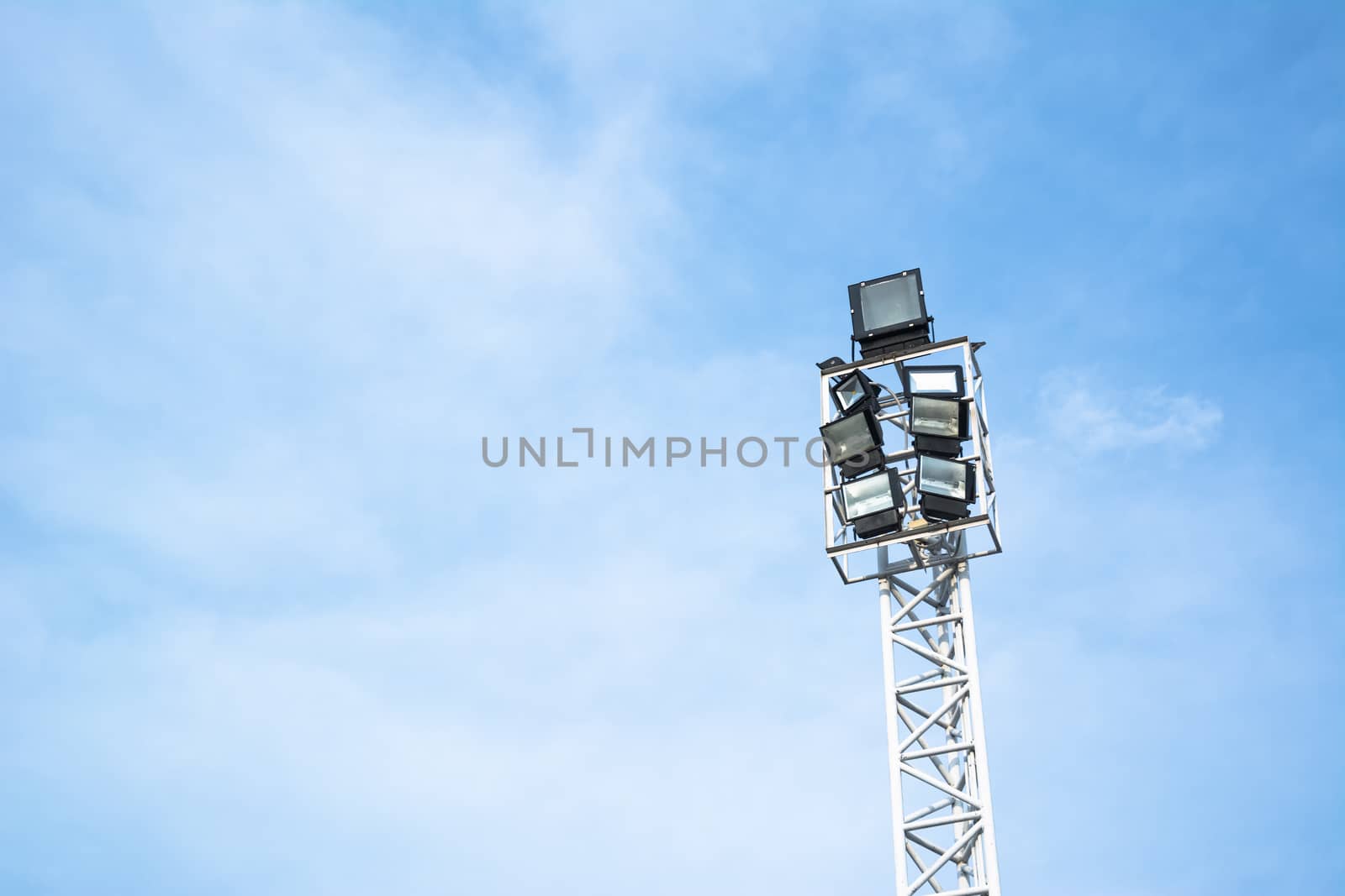 Spotlights electric poles with blue sky for background by ahimaone