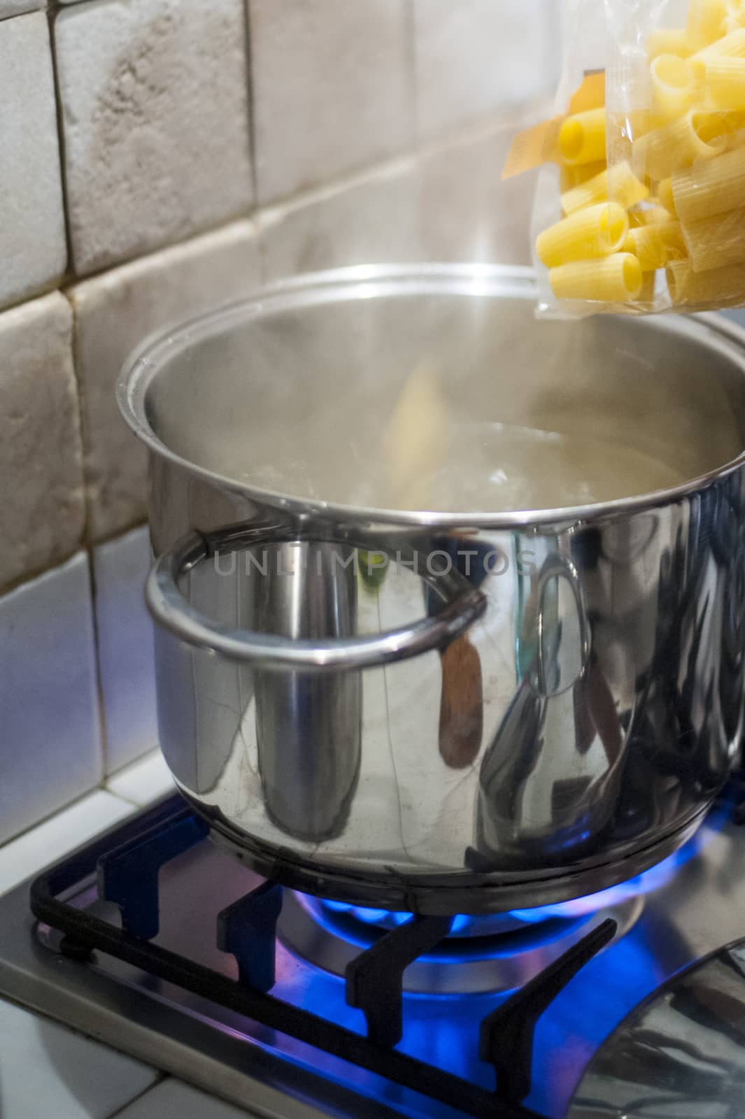 throw pasta into the pot of water on the stove fire