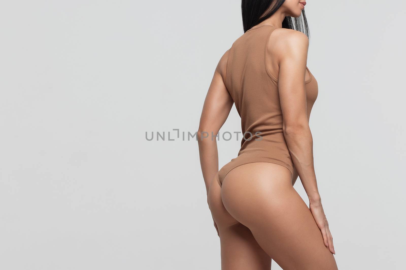 Female butt, white background. Beautiful female butt in a Thong by 3KStudio