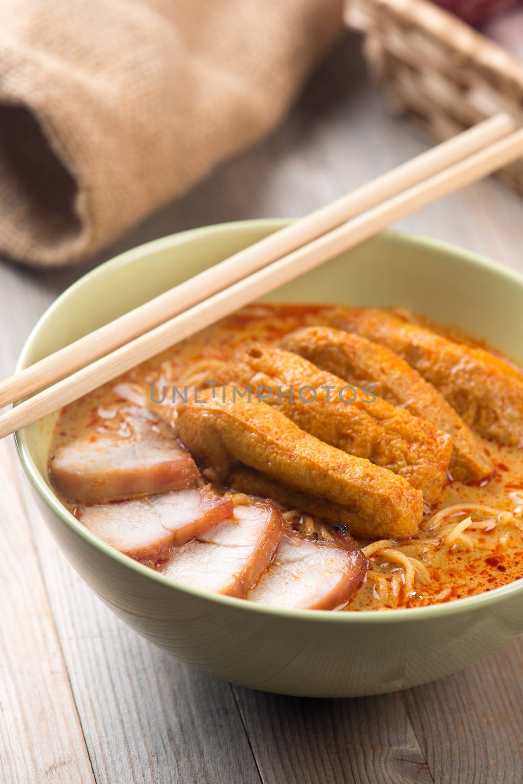 Hot and spicy Singaporean Curry Noodle or laksa mee, serve with chopsticks. Singapore cuisine.