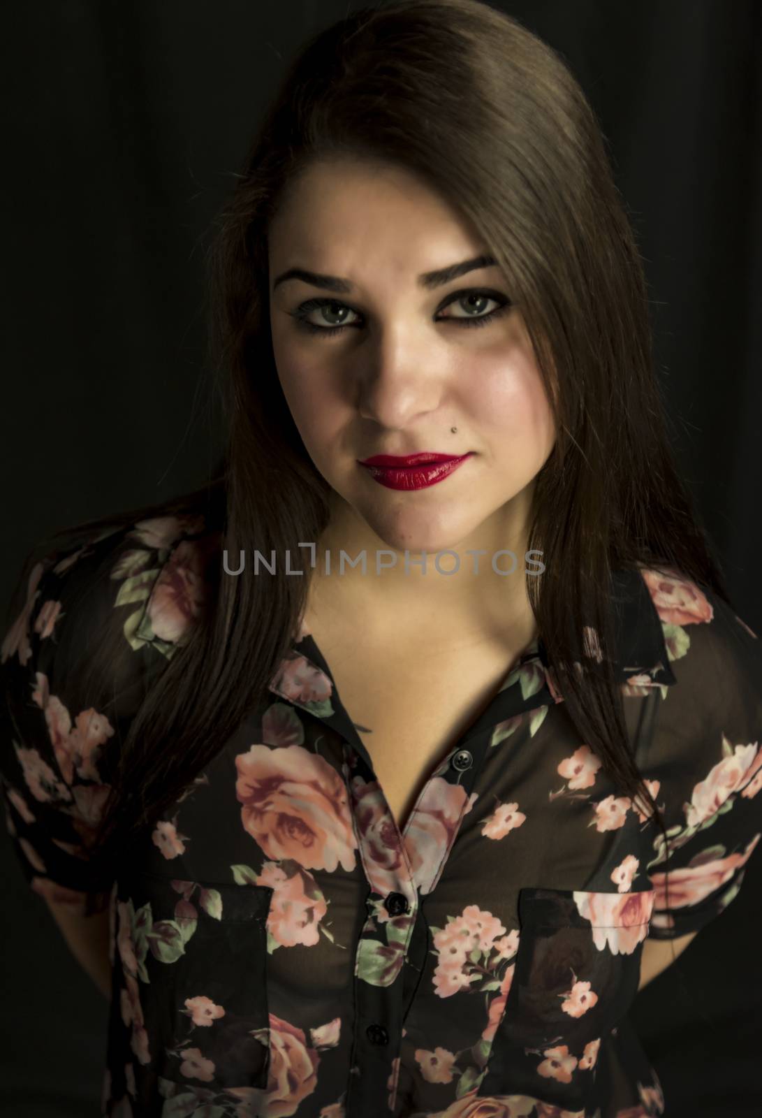 beautiful young woman in her 20s in a close-up portrait in studio