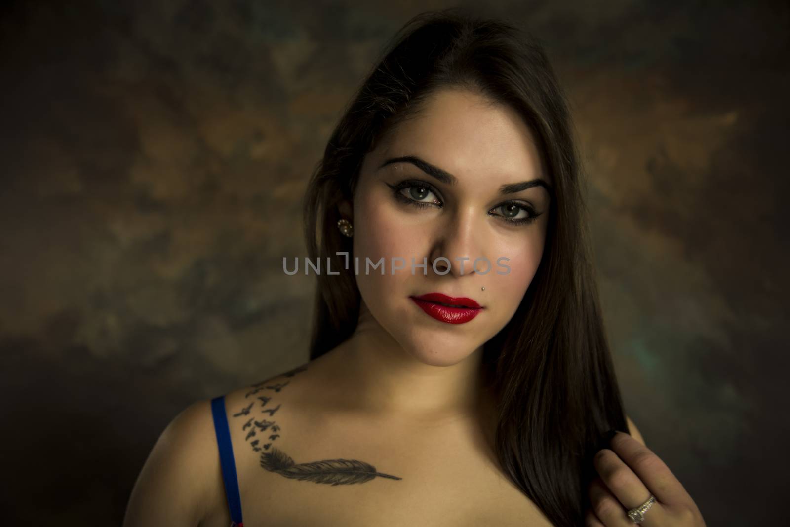 beautiful young woman in her 20s in a close-up portrait in studio