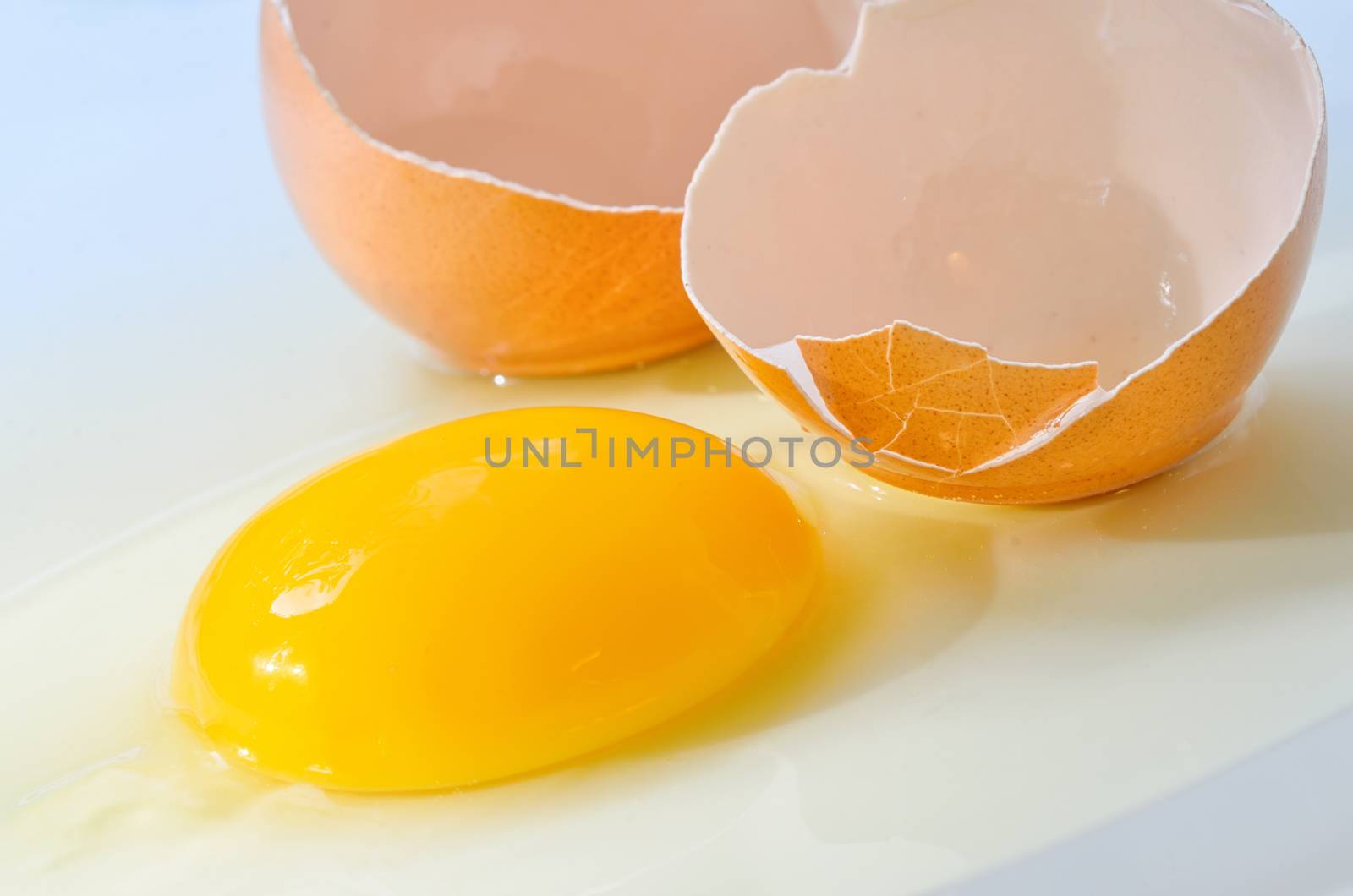 Broken fresh egg isolated on white table