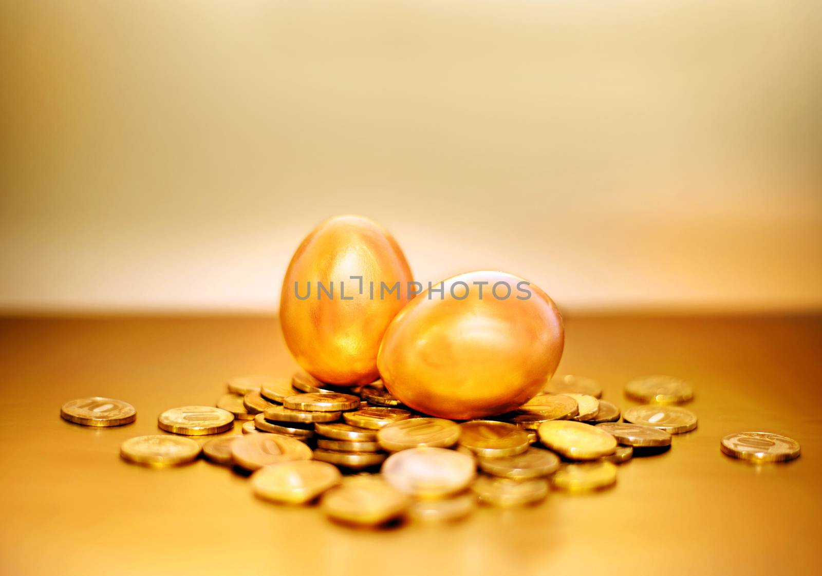 Gold coins and golden eggs, the concept of financial growth.