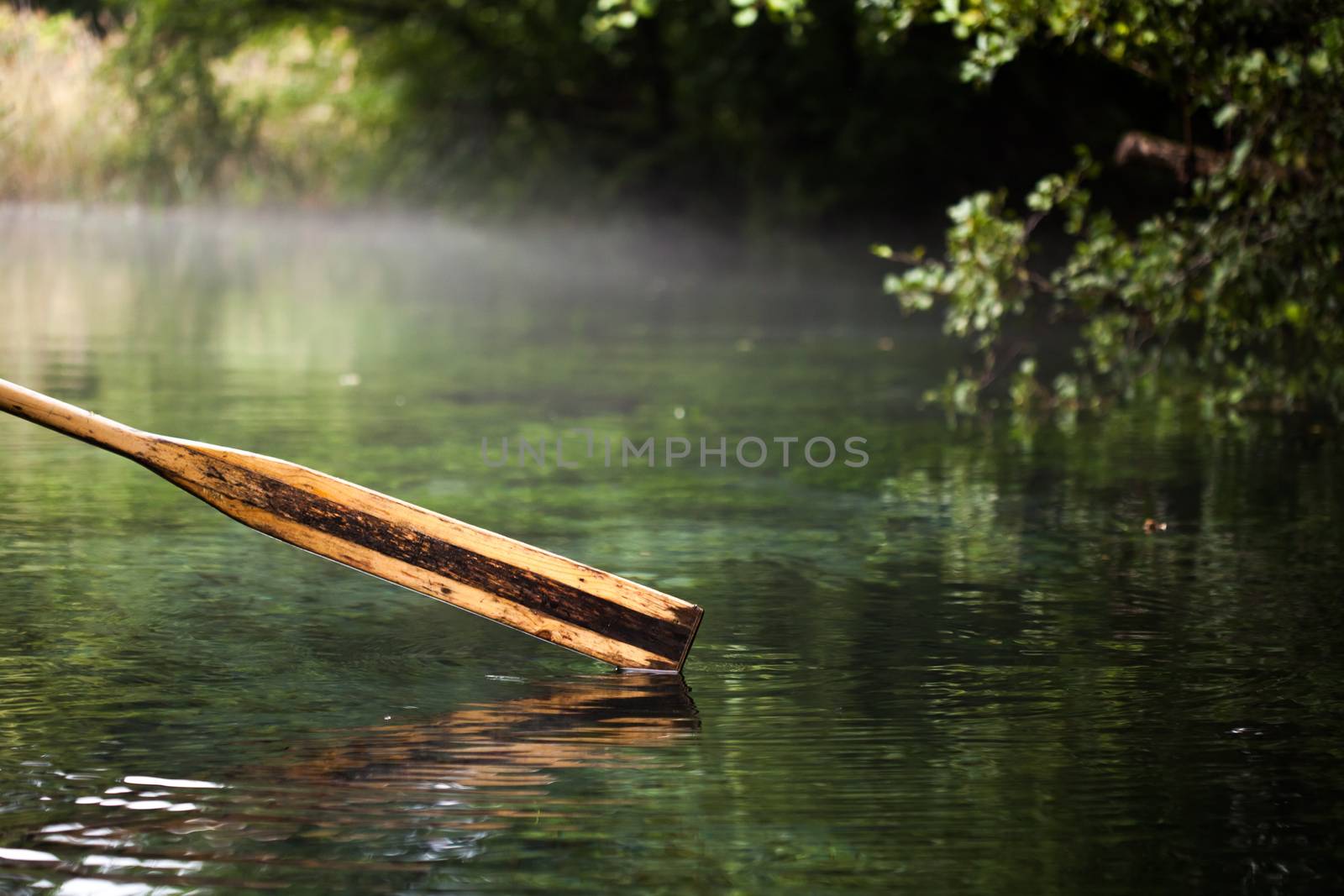 wooden paddle over misty water by kokimk