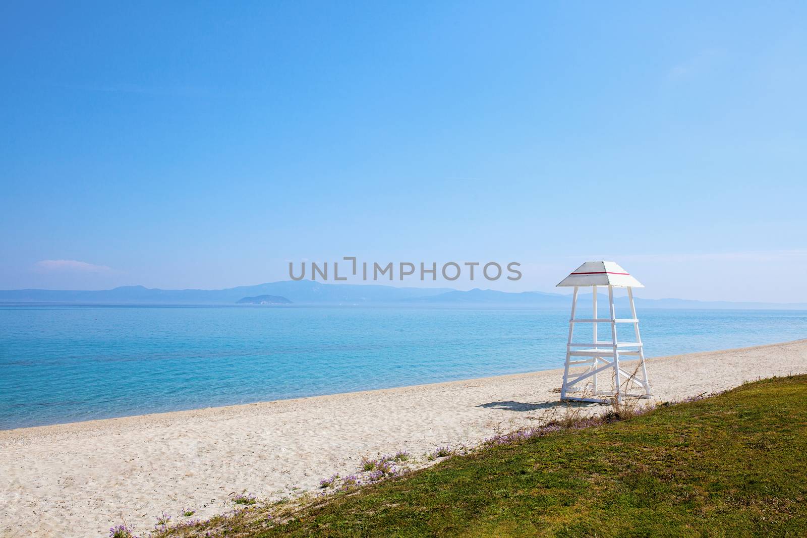 lifeguard tower on an empty beach near the ocean