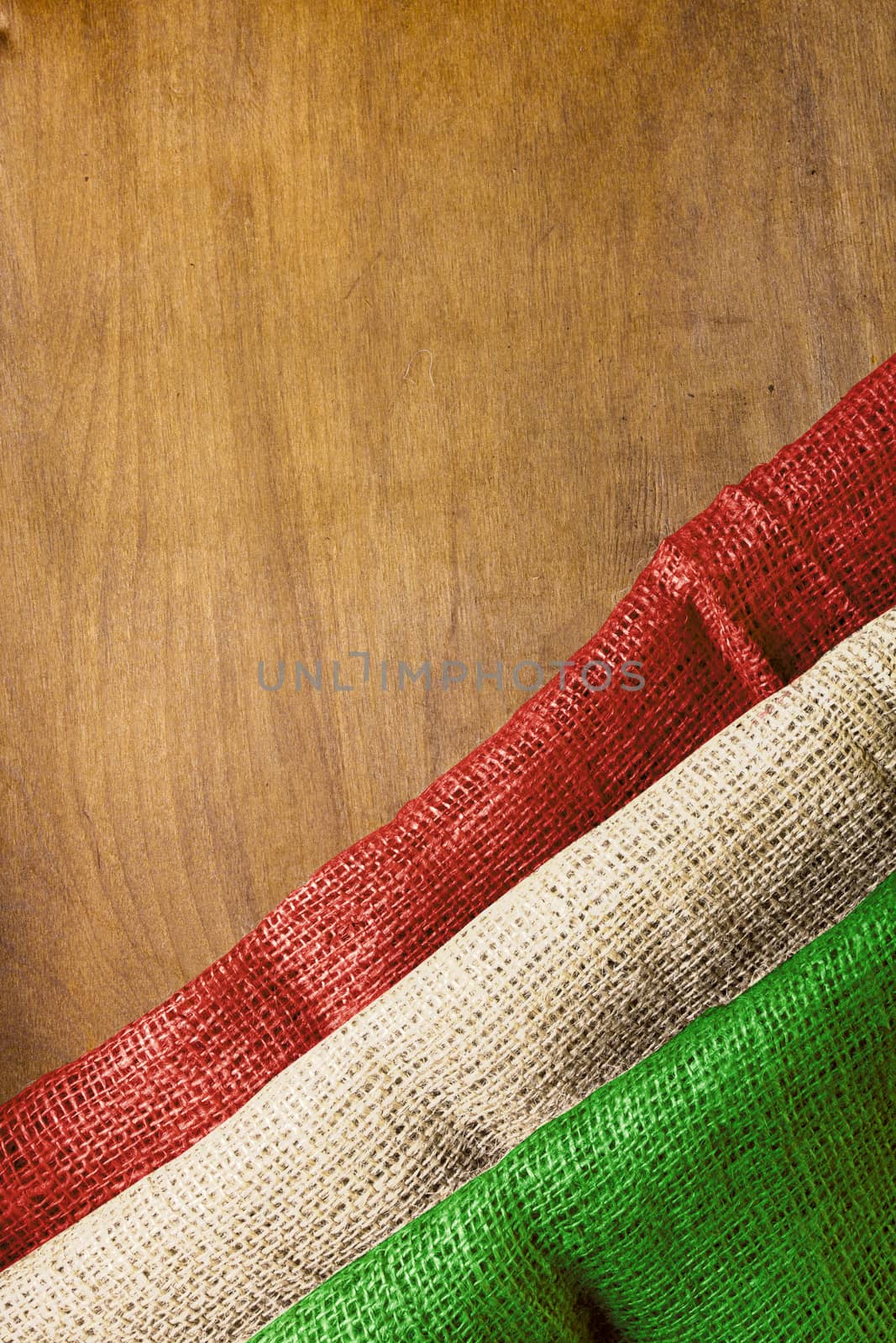 Flag of Hungary on a wooden background of rough fabric.