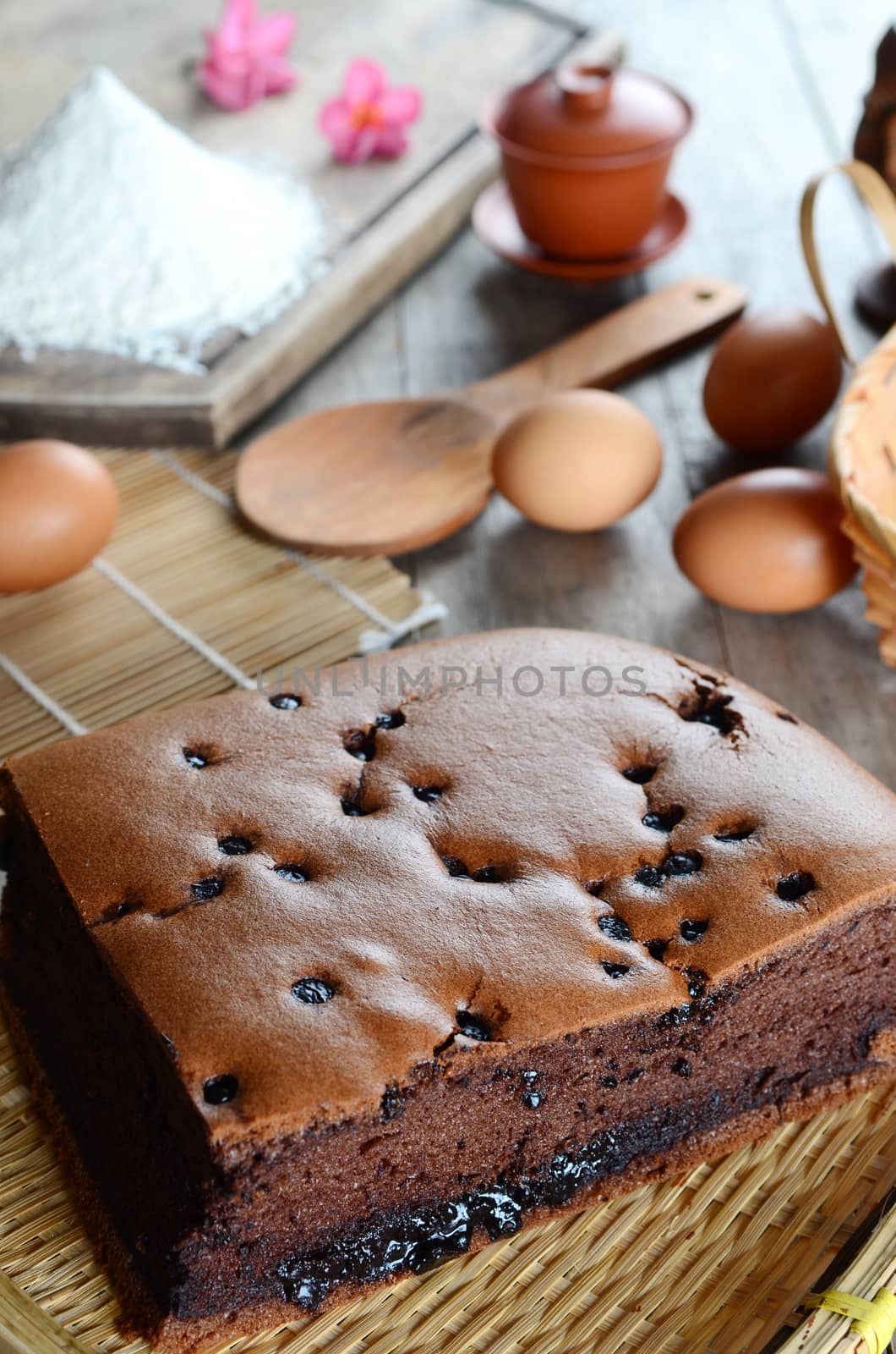 Taiwanese  chocolate sponge cake with bamboo weaving basket on wooden board