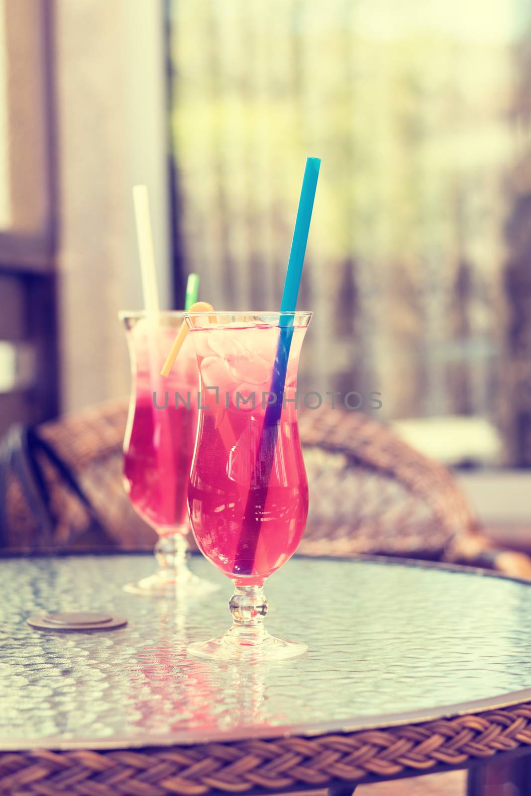 Fresh lemonade in transparent glasses on a street cafe table. Toned photo. Shallow depth of field