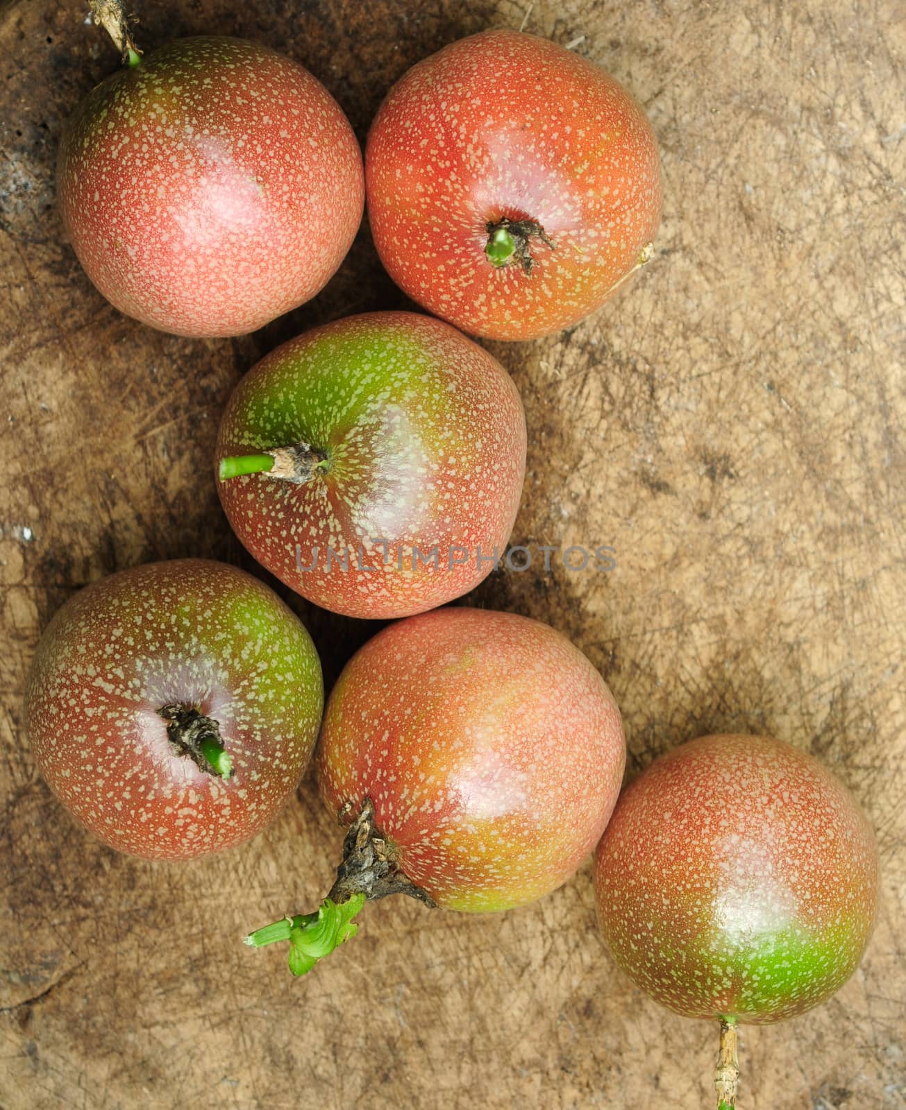 Passion fruits on old wooden background.