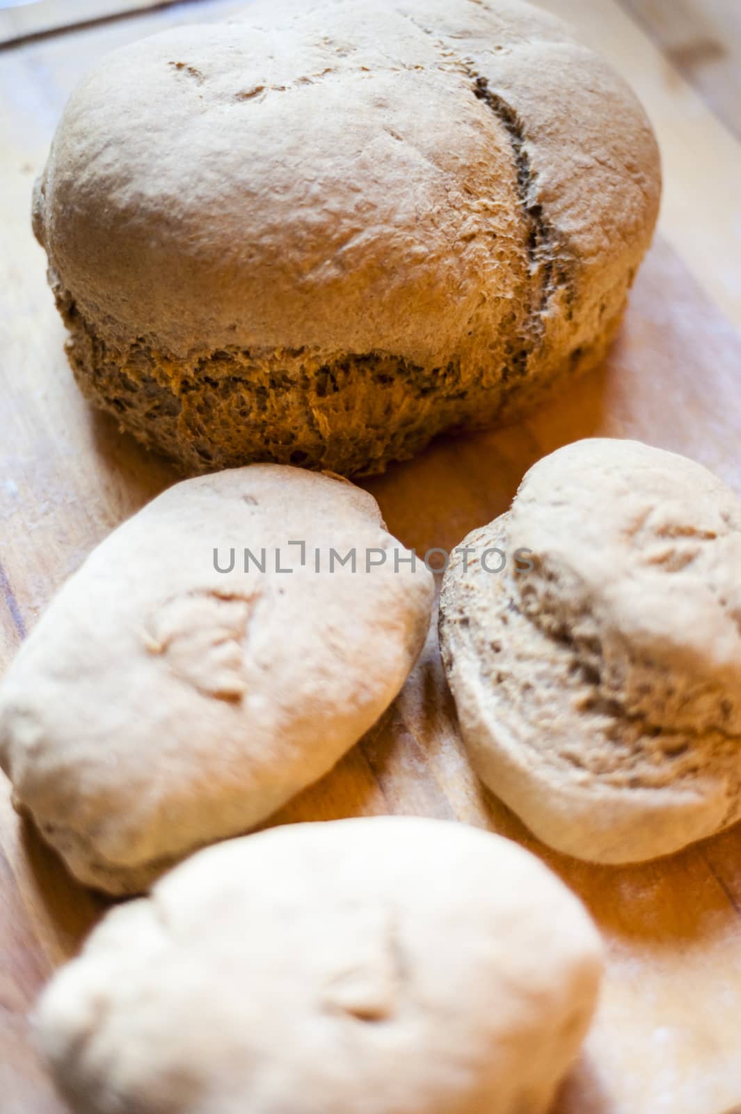 Homemade whole wheat bread with organic sourdough, wooden background