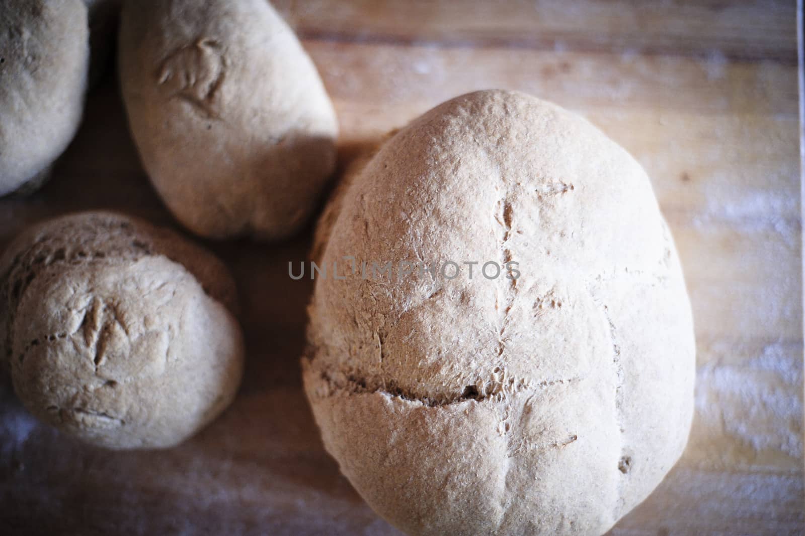 Homemade whole wheat bread with organic sourdough, wooden background