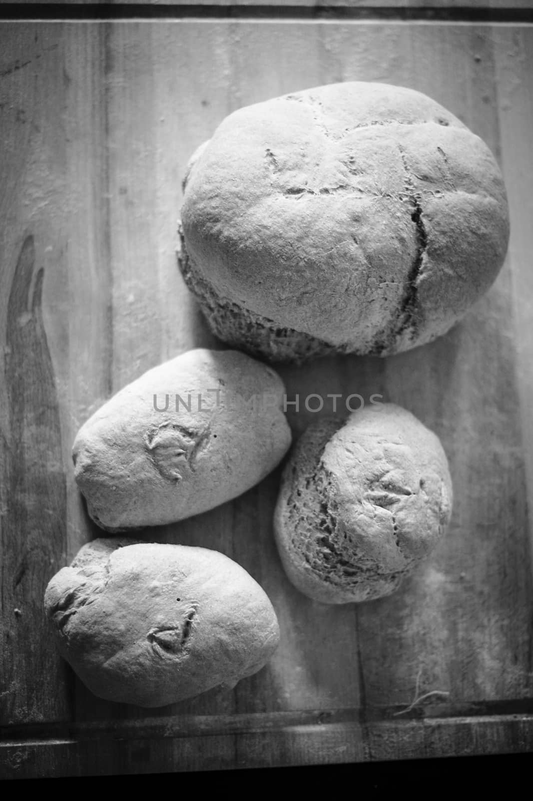 Homemade whole wheat bread with organic sourdough, wooden background