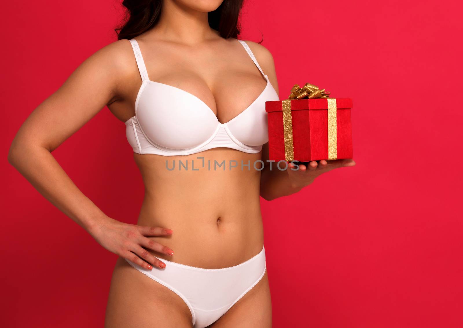Sexy voluptuous busty woman in white lingerie holding a gift box by Nobilior