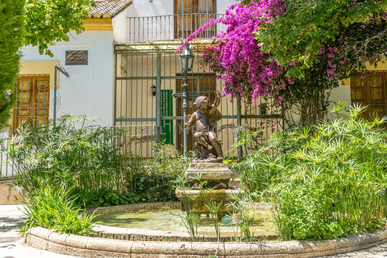 A water fountain in the city of Ronda Spain, Europe on a hot summer day with clear blue skies with blue sky