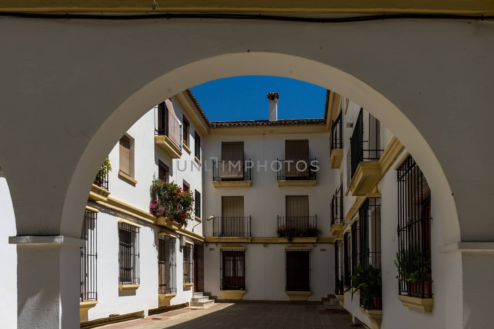 Counrtyard of a house in the street in the city of Ronda Spain, Europe on a hot summer day with clear blue skies