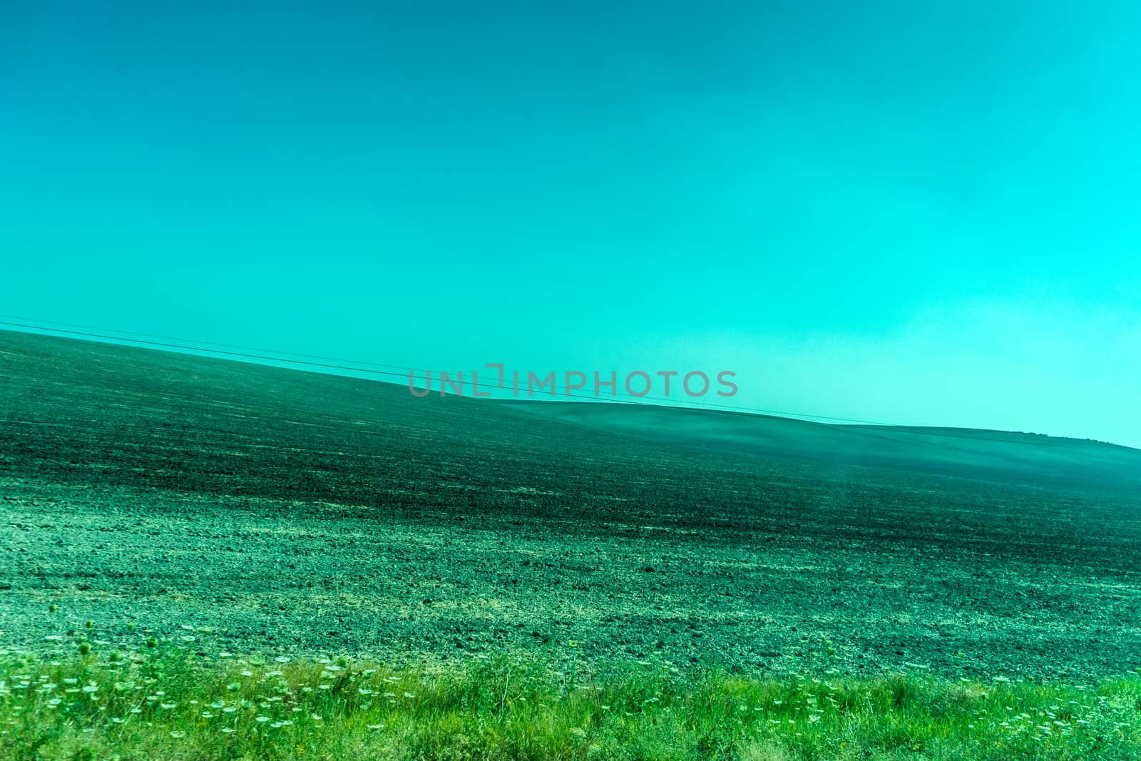 Greenery, Mountains, Farms and Fields on the outskirts of Ronda Spain, Europe on a hot summer day with clear blue skies