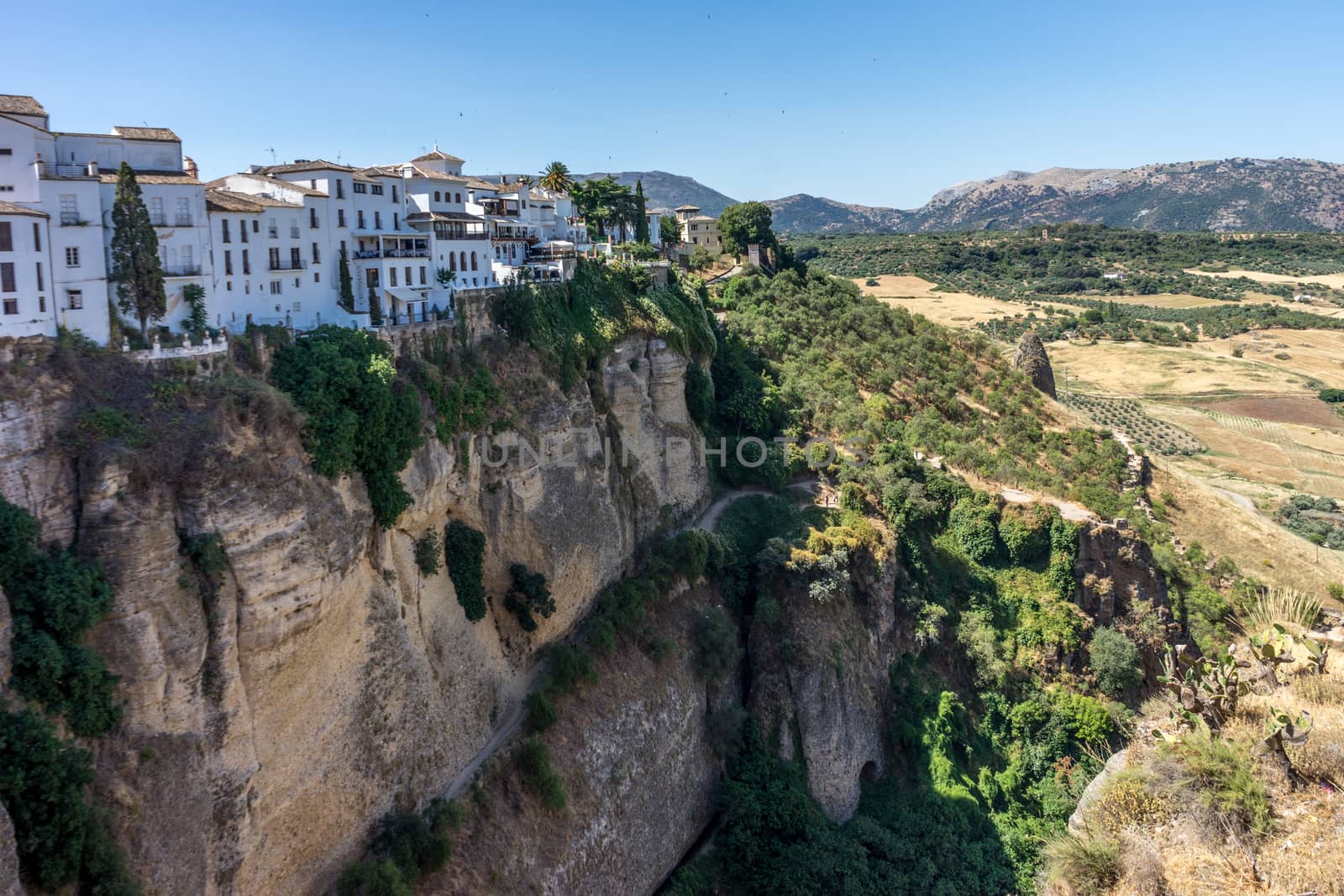 A gorge in the city of Ronda Spain, Europe on a hot summer day with clear blue skies