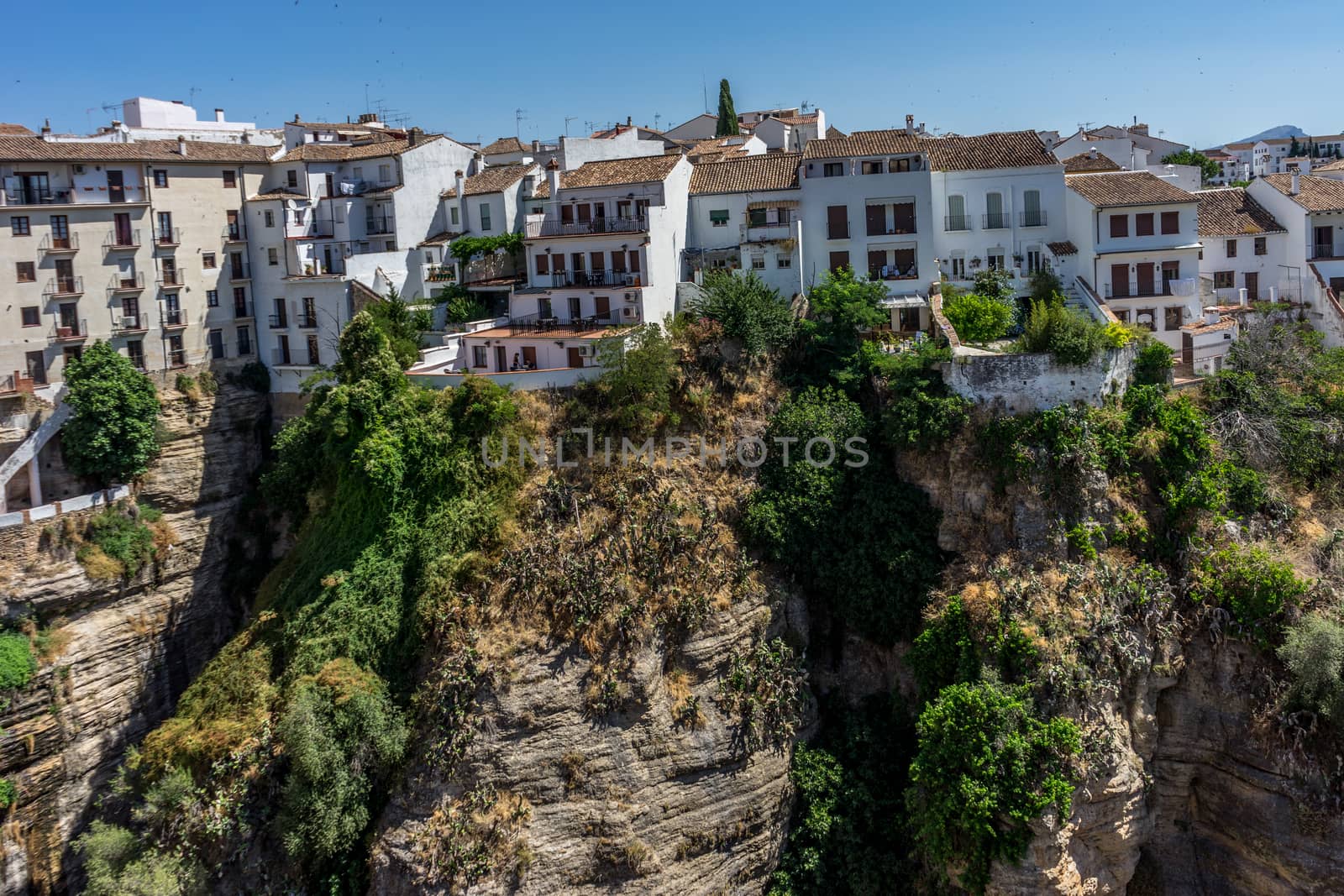 A gorge in the city of Ronda Spain, Europe on a hot summer day with clear blue skies