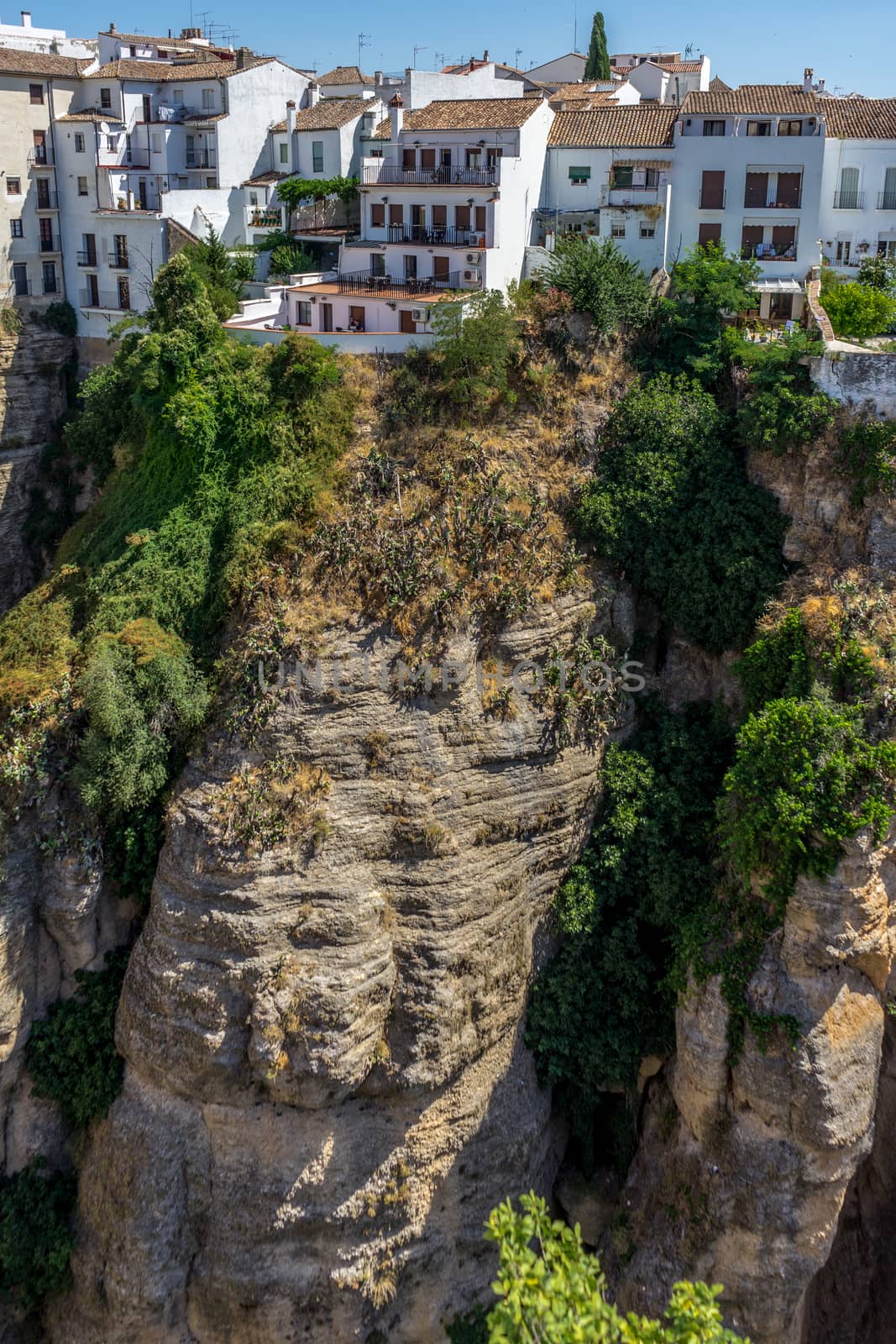 A gorge in the city of Ronda Spain, Europe on a hot summer day with clear blue skies