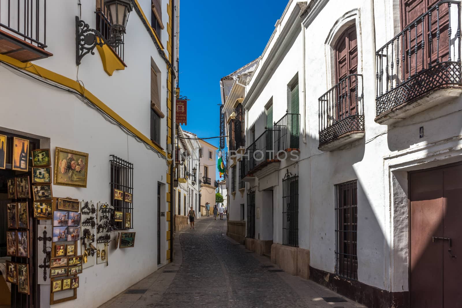 A streetside shop in the city of Ronda Spain, Europe on a hot su by ramana16