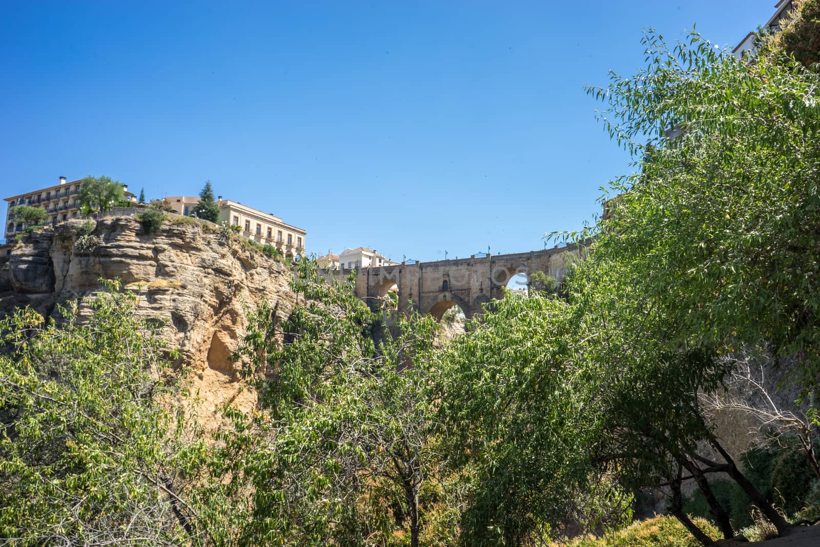 A gorge in the city of Ronda Spain, Europe on a hot summer day with clear blue skies