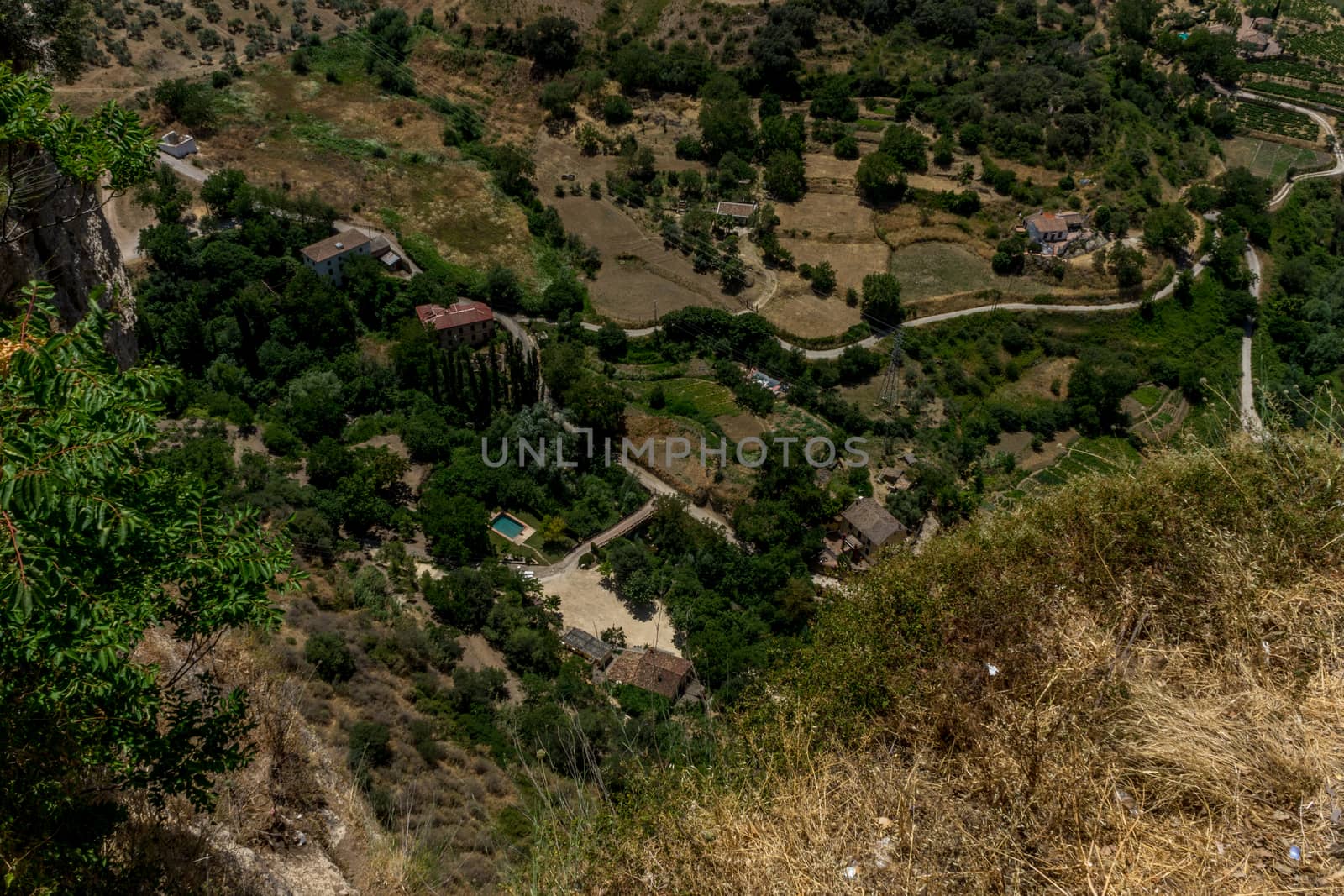 Greenery, Mountains, Farms and Fields on the outskirts of Ronda Spain, Europe on a hot summer day with clear blue skies