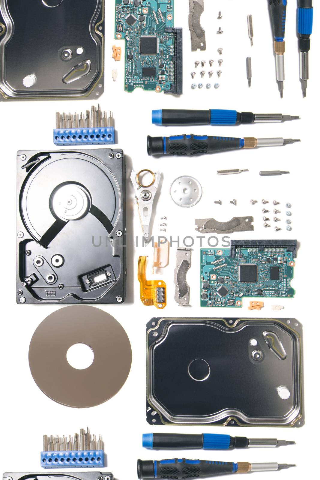 Disassembled hard disk drive parts isolated on a white background.