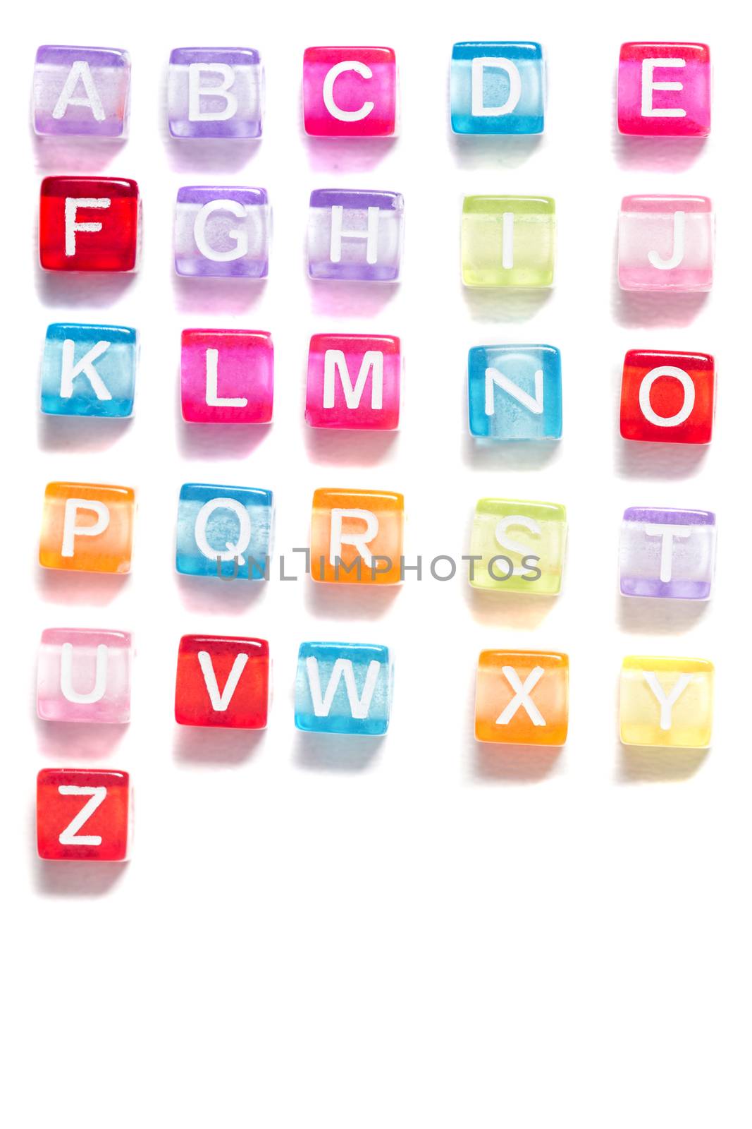 Colorful plastic beads alphabet isolated on a white background.