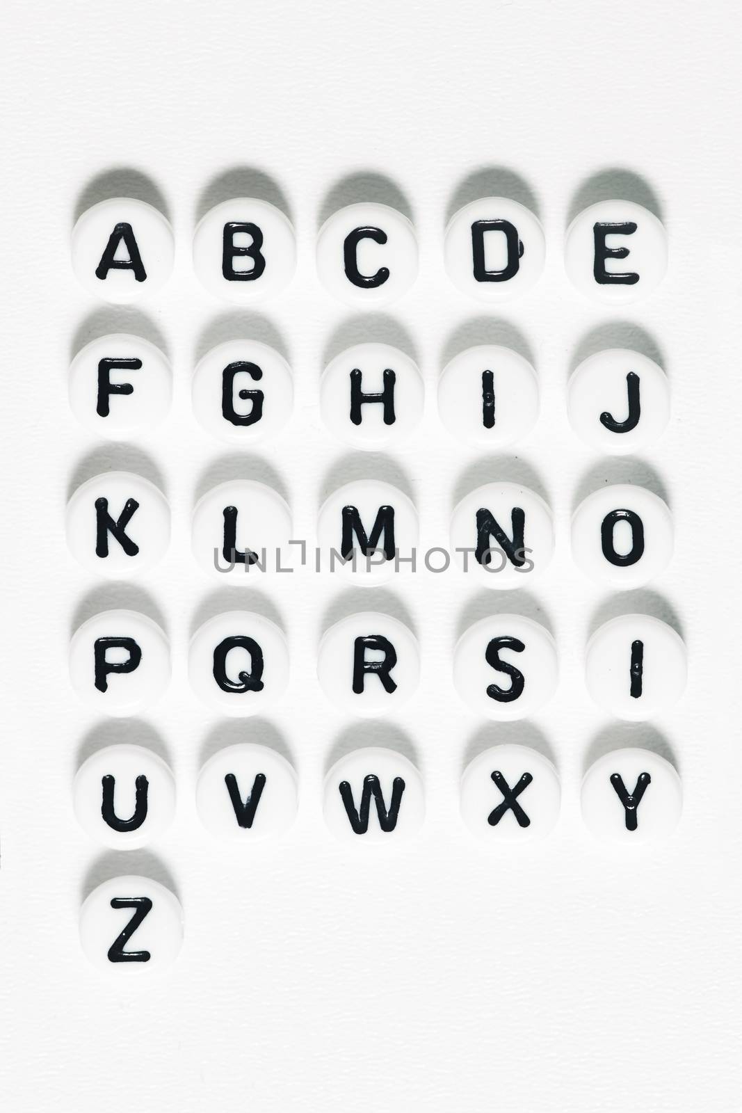 Plastic beads alphabet isolated on a white background.