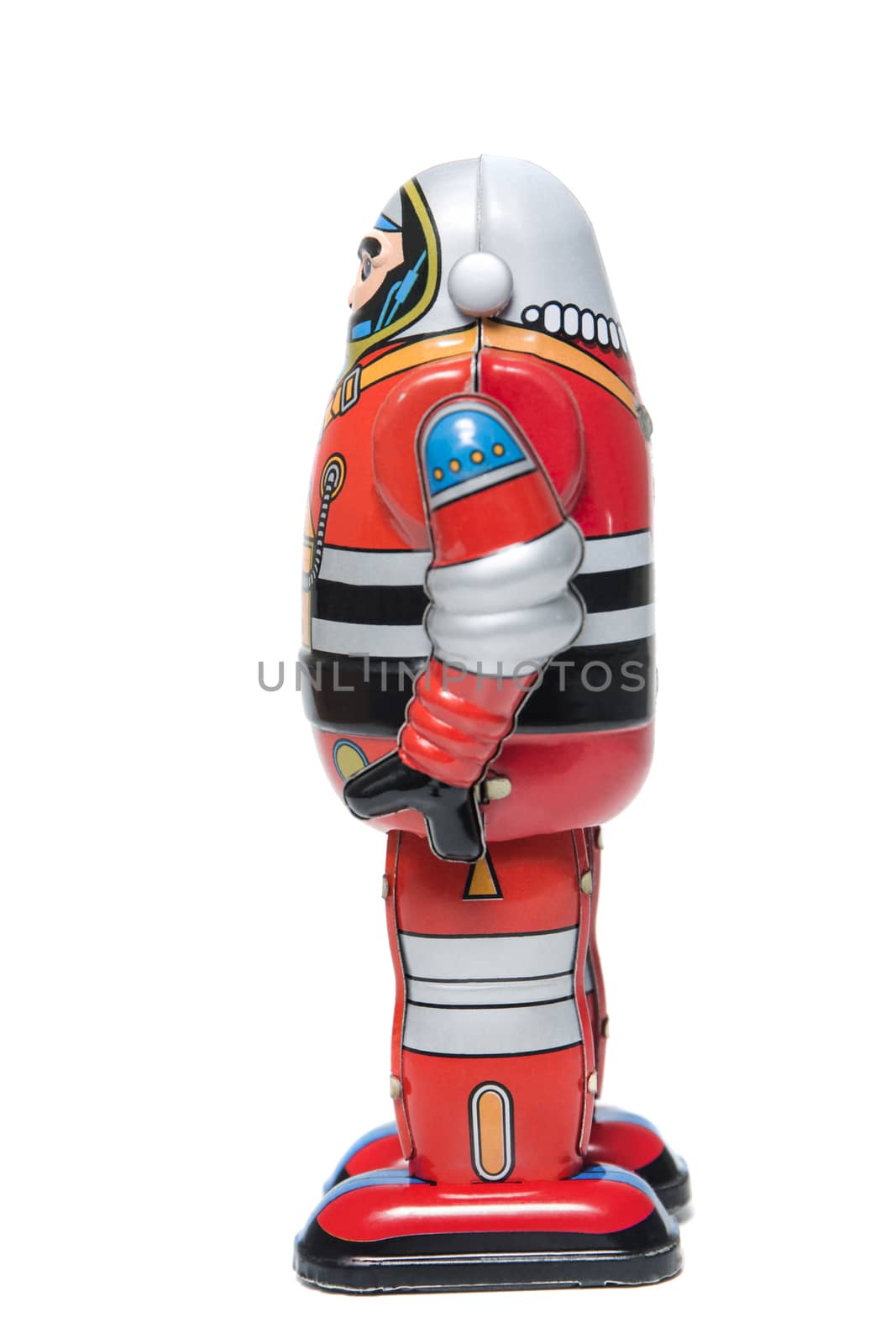 Vintage tin robot toy isolated on a white background.