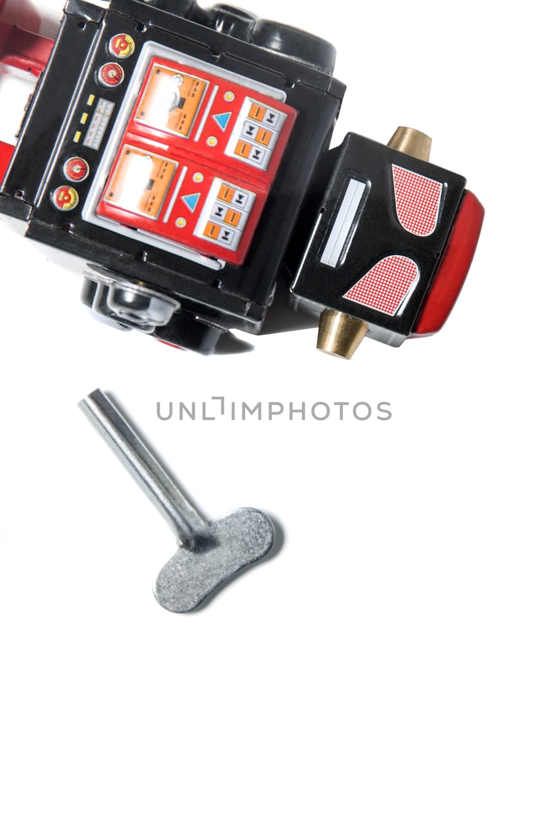 Vintage tin robot toy isolated on a white background.