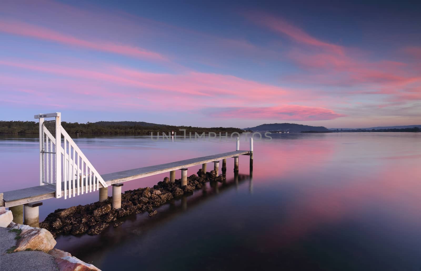 Saratoga jetty at sunset with soft light and  pink and blue hues.  Perfect place to relax or fish.