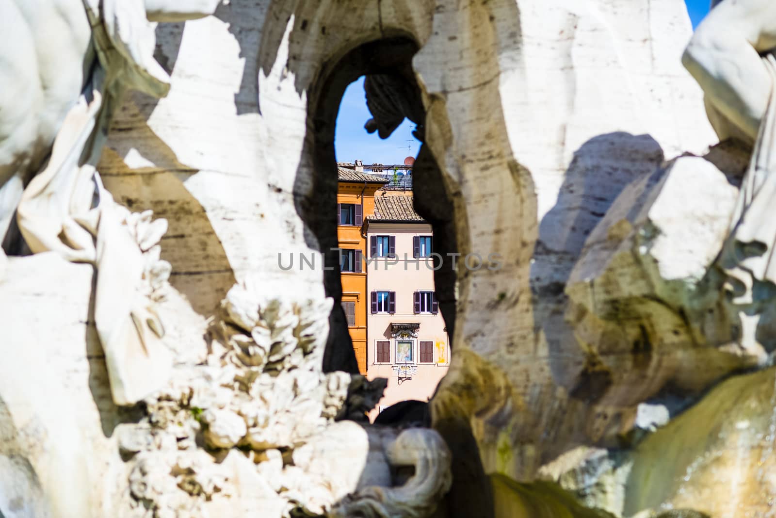 Italy, Rome, Piazza Navona, view of the palaces through the fountain of the Bernini fountain of the four rivers