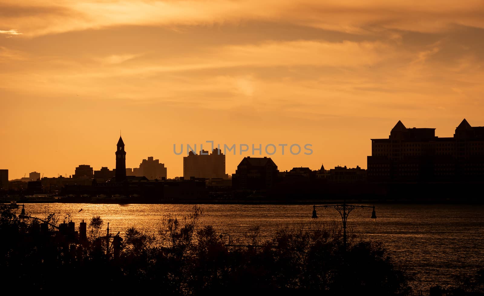 Urban warm sunset with the silhouette of a city skyline