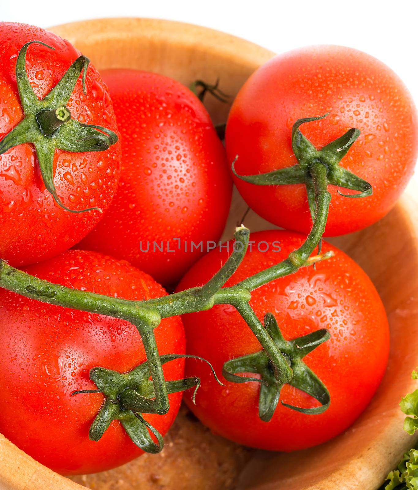 Fresh red vine tomatoes in a wooden bowl on the table  by stuartmiles