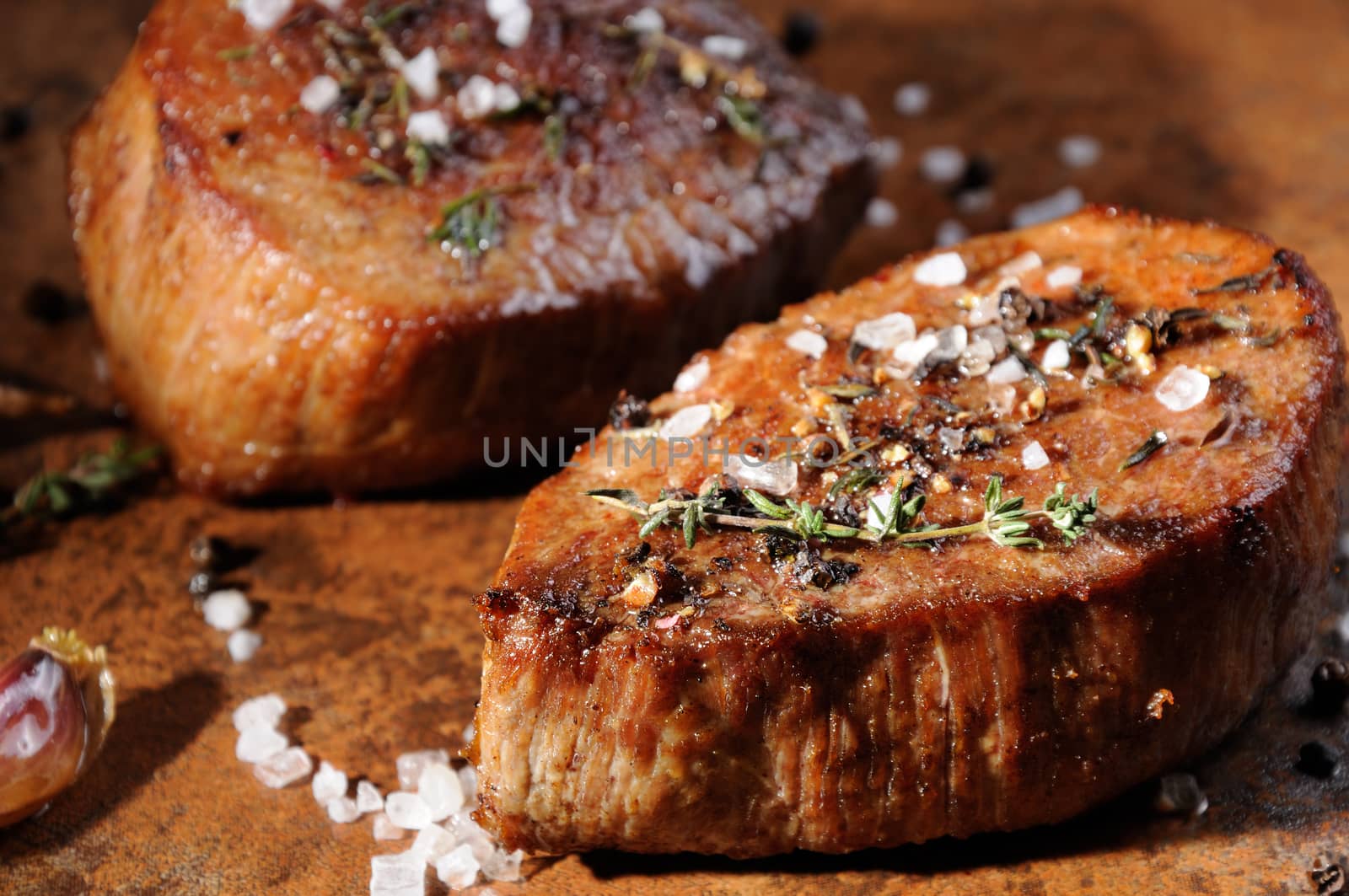 Beef steak. Juicy medium Rib Eye steak slices  herbs spices and salt.