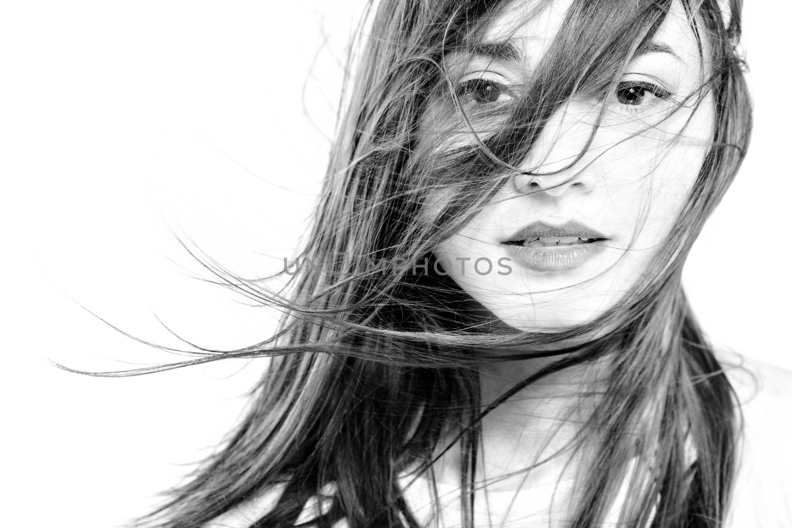 black and white high key portait of a girl with long windy hair