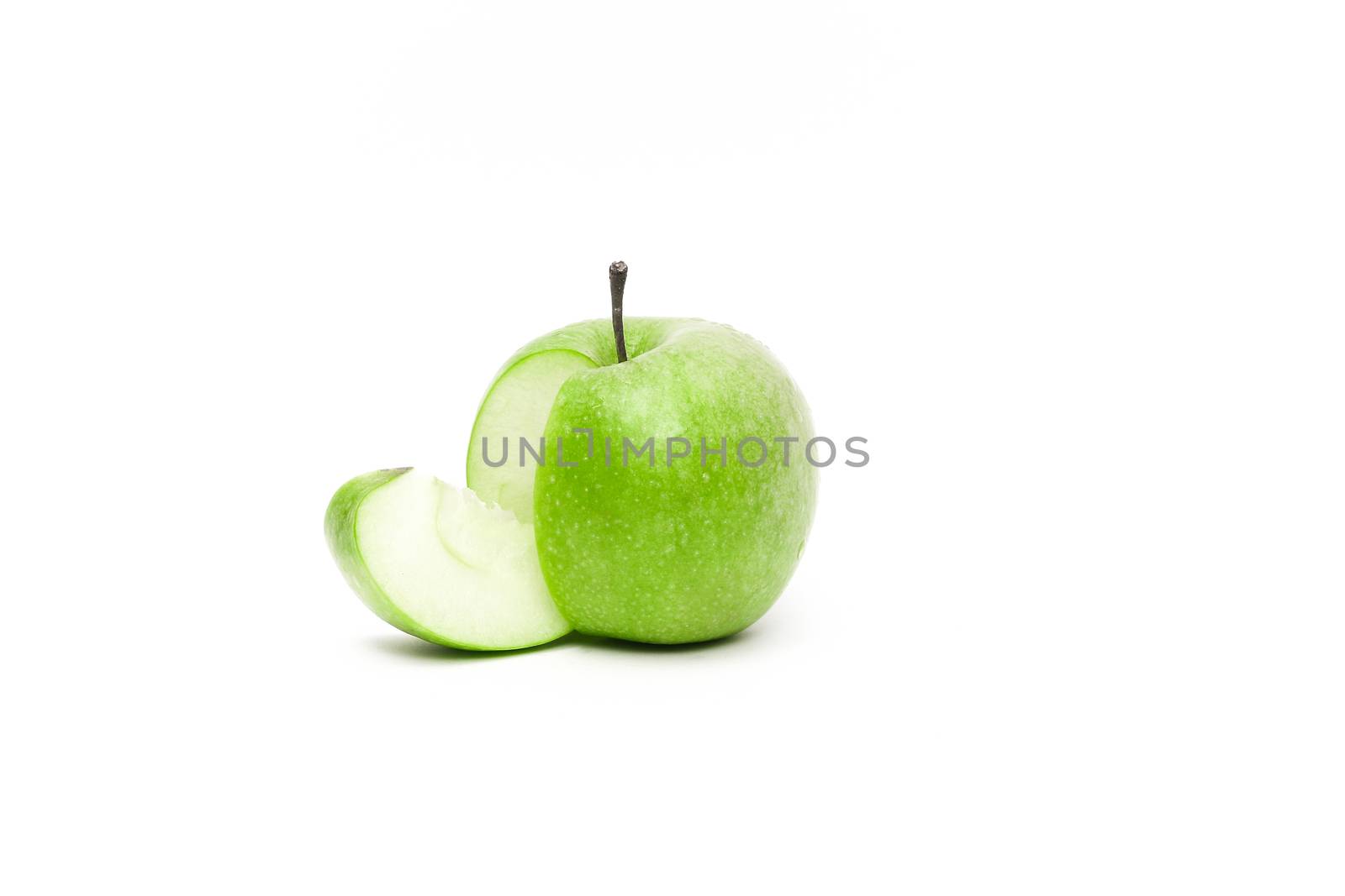Gorgeous ripe fresh apple with a sliced piece falling from it
