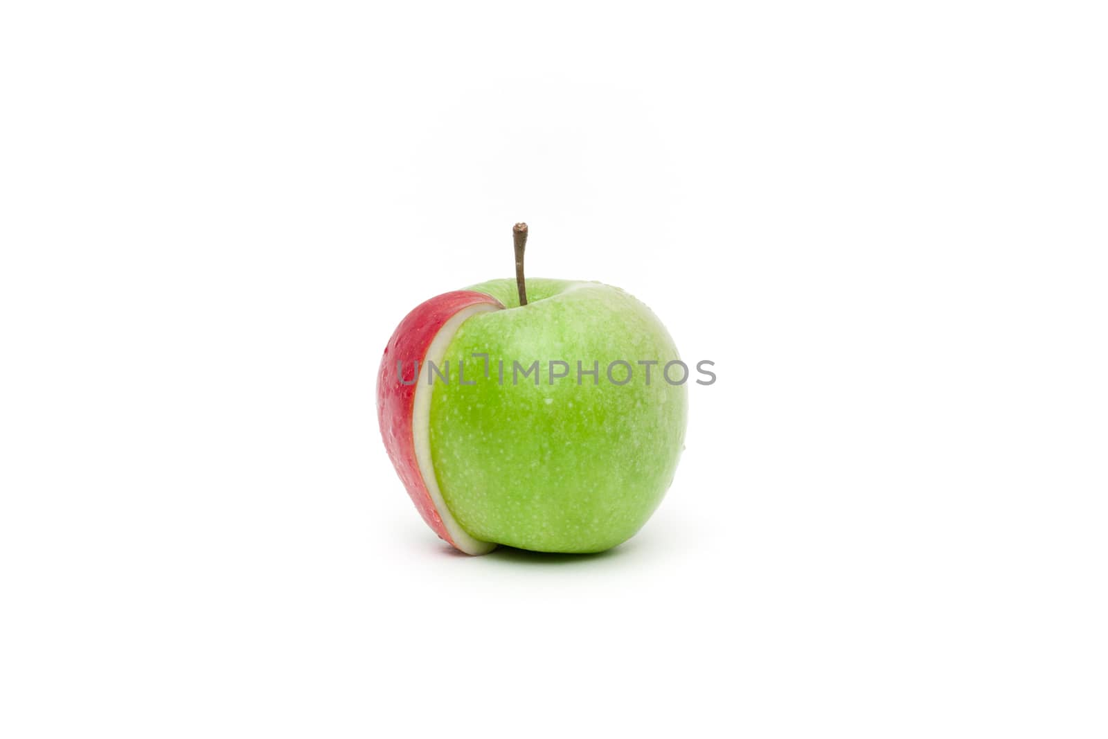 Conceptual view on a green fresh apple with a red slice attached to