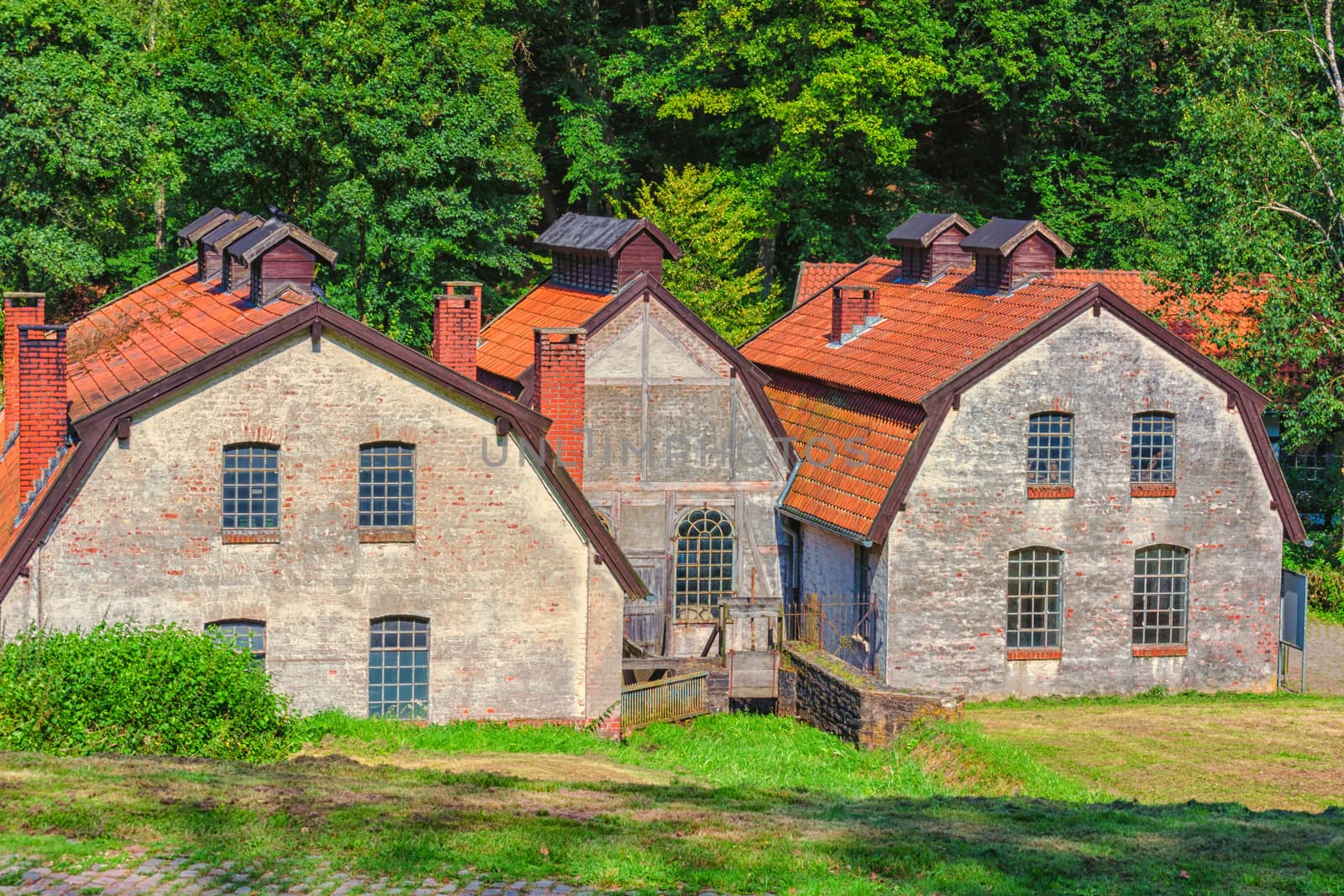 Large old abandoned factory building of a blacksmith and watermill