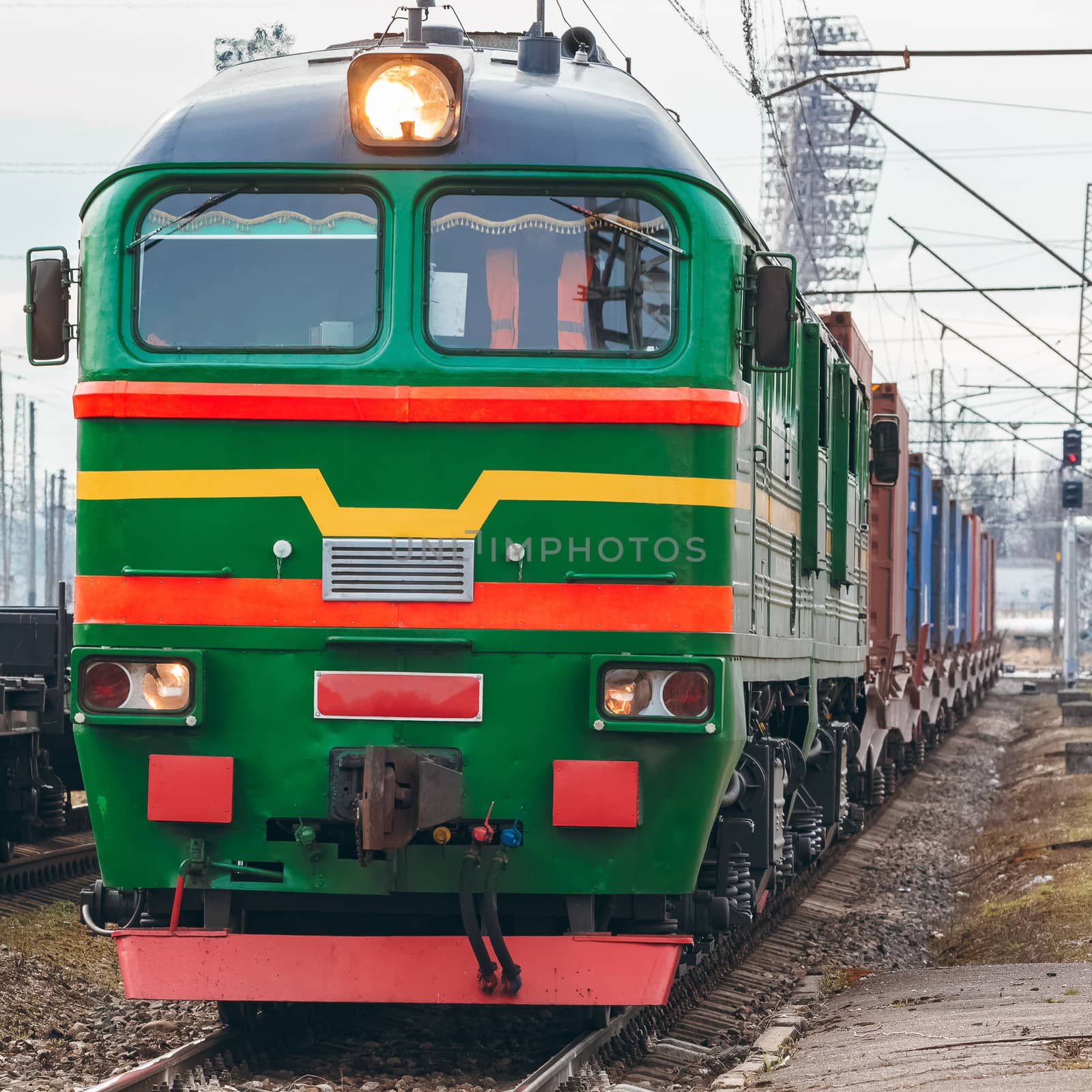 Green diesel cargo locomotive. Freight train in action