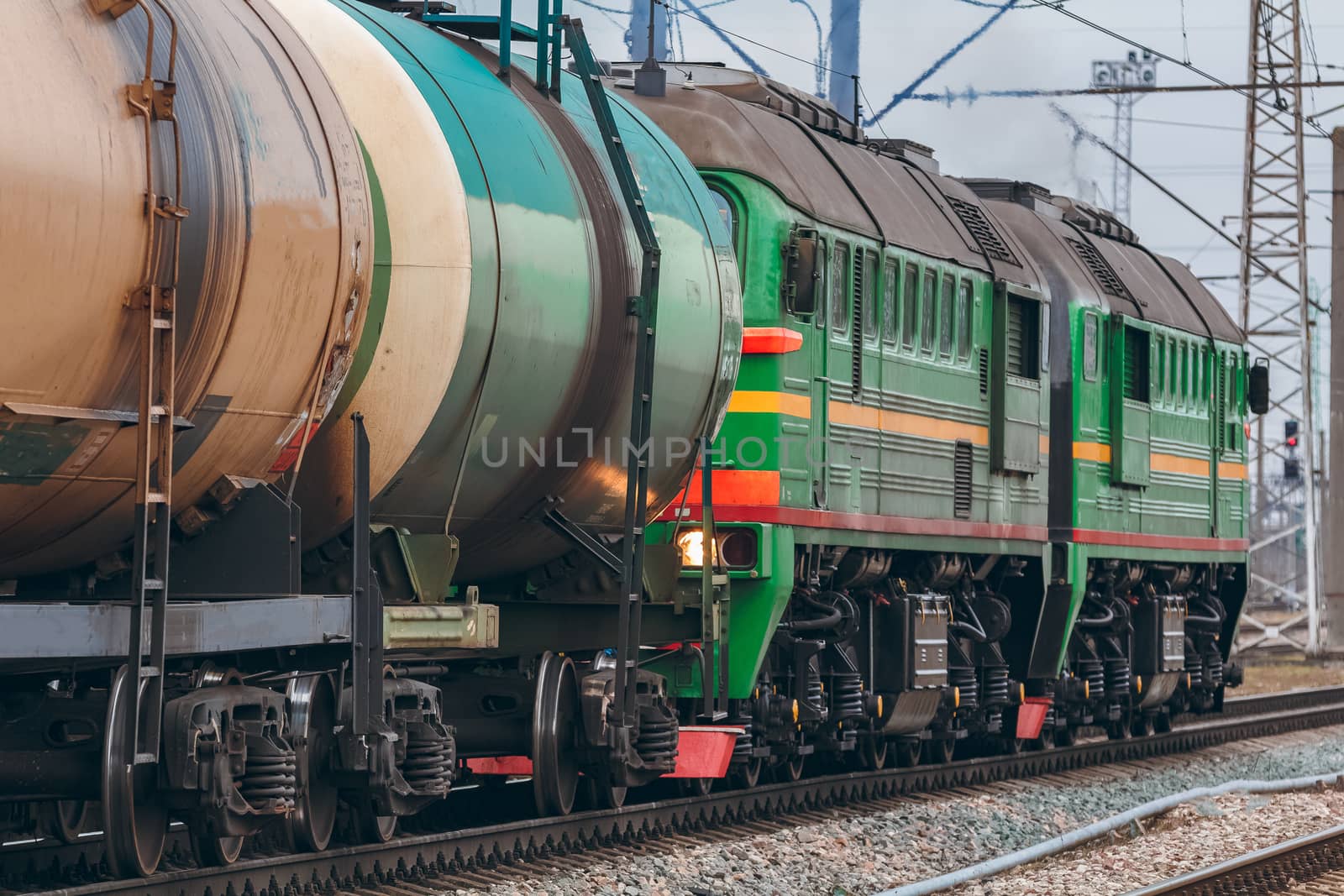 Green diesel cargo locomotive. Freight train in action