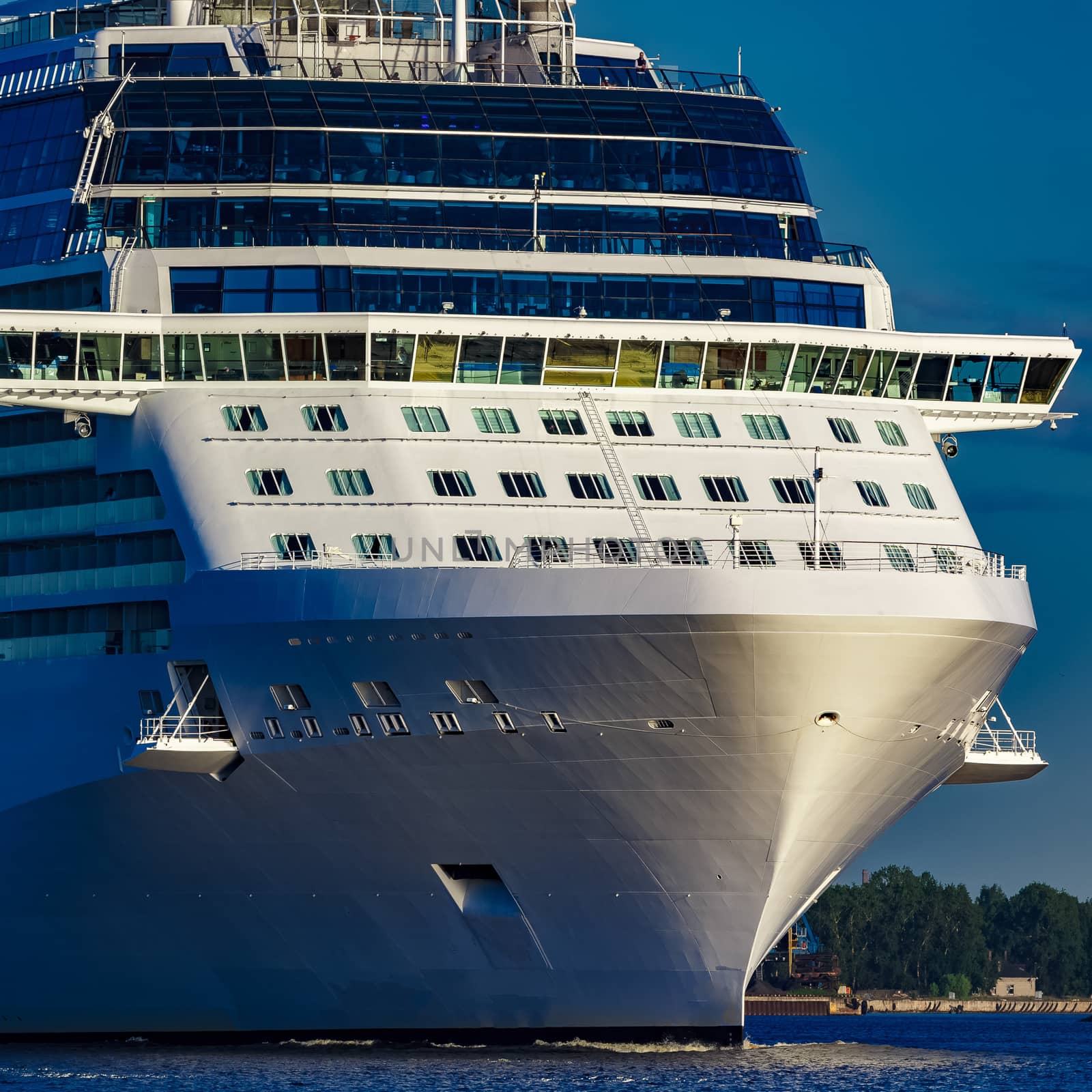 White giant brand new passenger ship moving in clear summer day