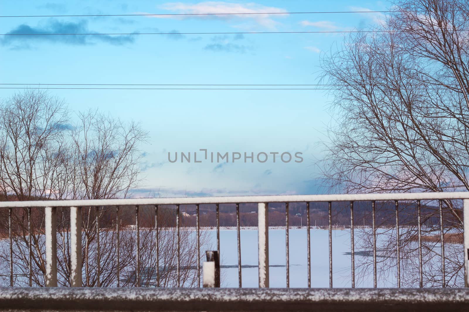 Winter landscape view on frozen road and lake river