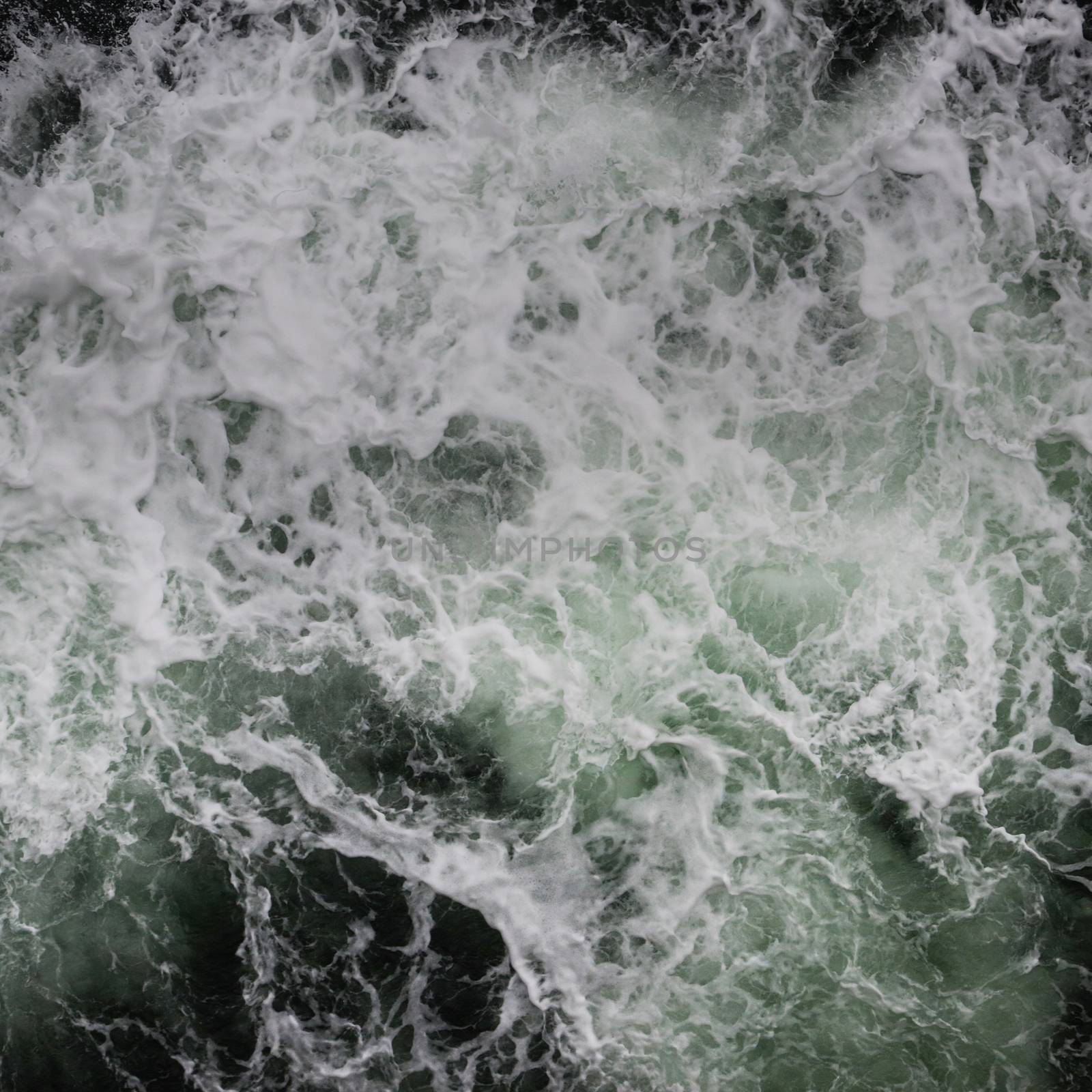 Big water splash seen from above a boat